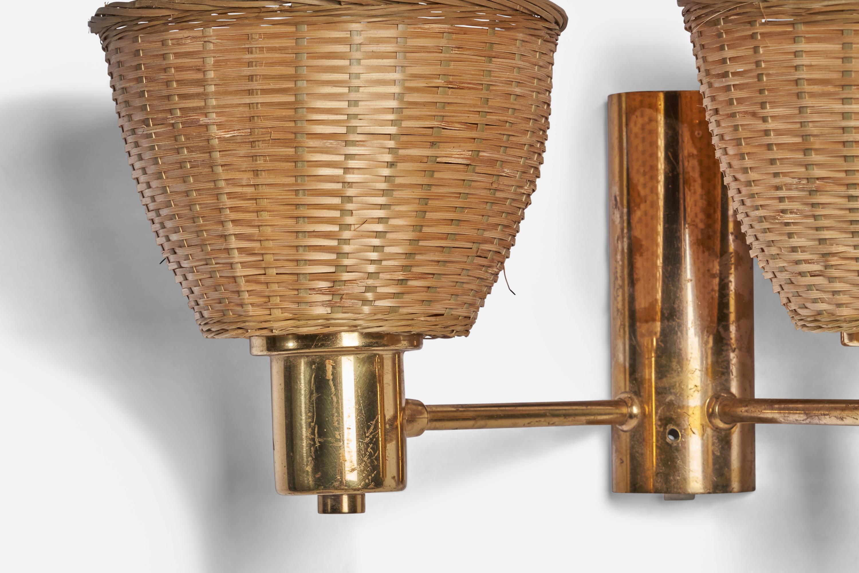 A two-armed brass and rattan wall light designed and produced in Sweden, 1960s.

Overall Dimensions (inches): 8” H x 15” W x 7.5” D
Bulb Specifications: E-26 Bulb
Number of Sockets: 2
All lighting will be converted for US usage. We are unable to