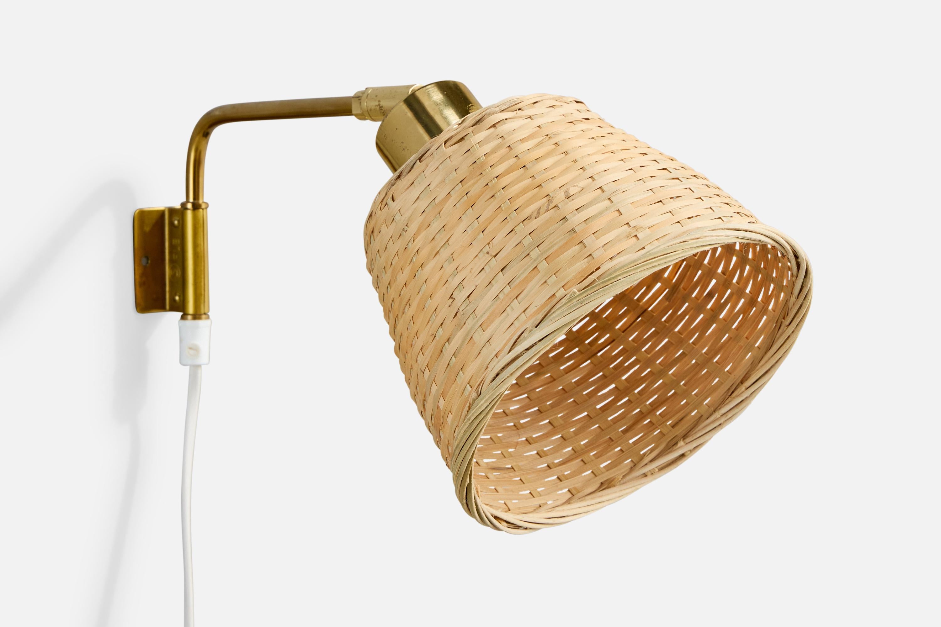 An adjustable brass and rattan wall light designed and produced in Sweden, 1960s.

Overall Dimensions (inches): 8.25