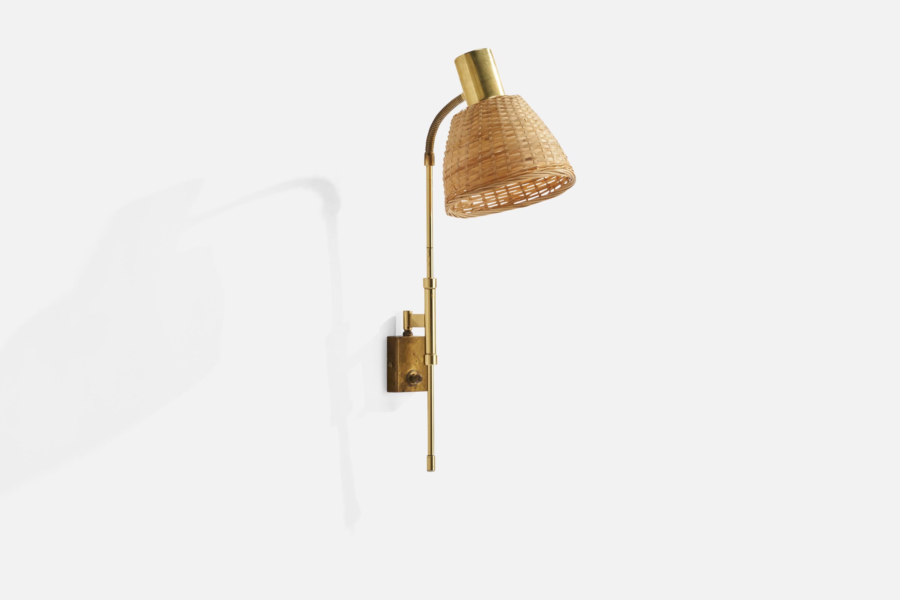 An adjustable brass and rattan wall light designed and produced in Sweden, c. 1970s.

Overall Dimensions (inches): 24” H x 12” W x 8”  D
Back Plate Dimensions (inches): 3” H x 2.25” W x .75”  D
Bulb Specifications: E-26 Bulb
Number of Sockets: 1
All