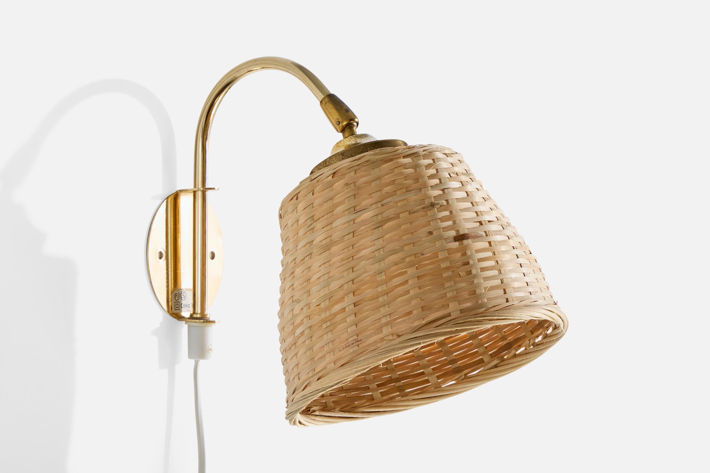 An adjustable brass and rattan wall light designed and produced in Sweden, c. 1970s.

Overall Dimensions (inches): 9.5