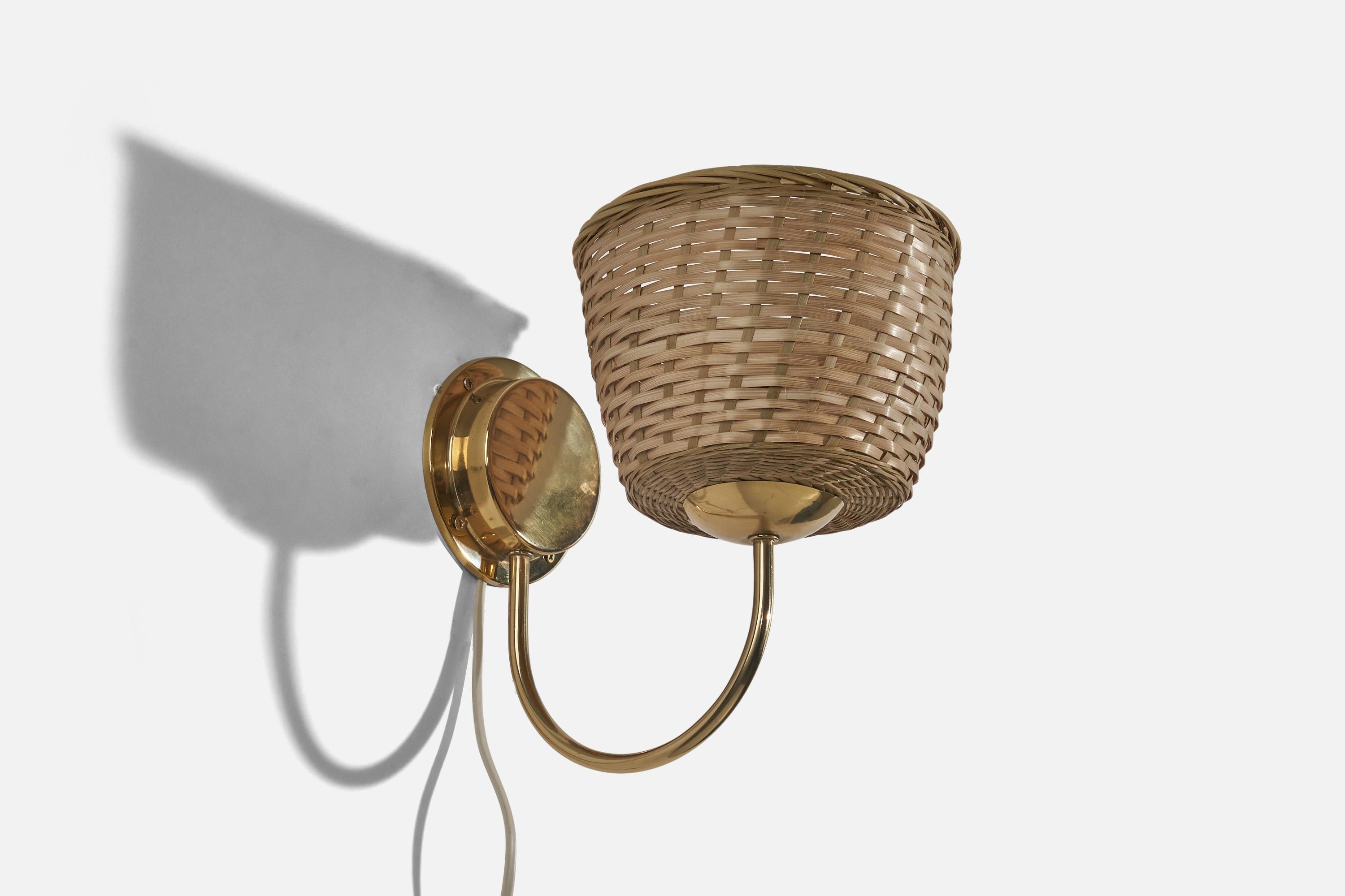 A brass and rattan wall light designed and produced in Sweden, c. 1940s.

Lampshade can be purchased with the lamp.
Dimensions of back plate (inches) : 4.31 x 4.31 x 1.18 (H x W x D).