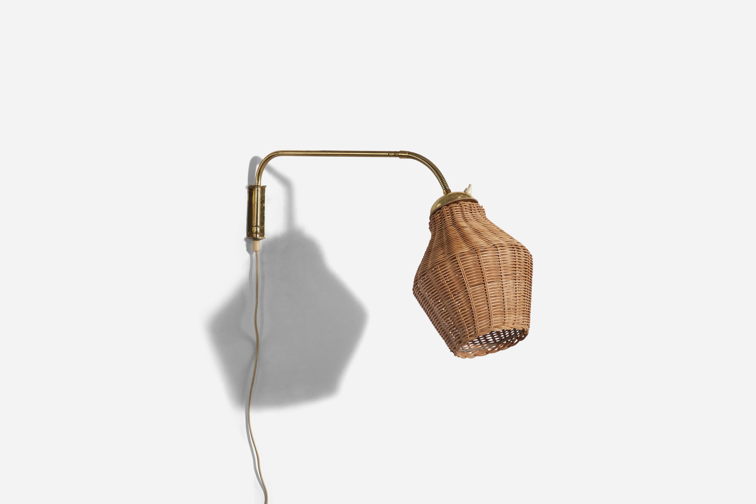 A brass and rattan wall light designed and produced in Sweden, c. 1940s.

Sold with Lampshade. 
Stated dimensions refer to the Sconce with the Shade.
Variable dimensions, measured as illustrated in the first image. 
Dimensions of back plate