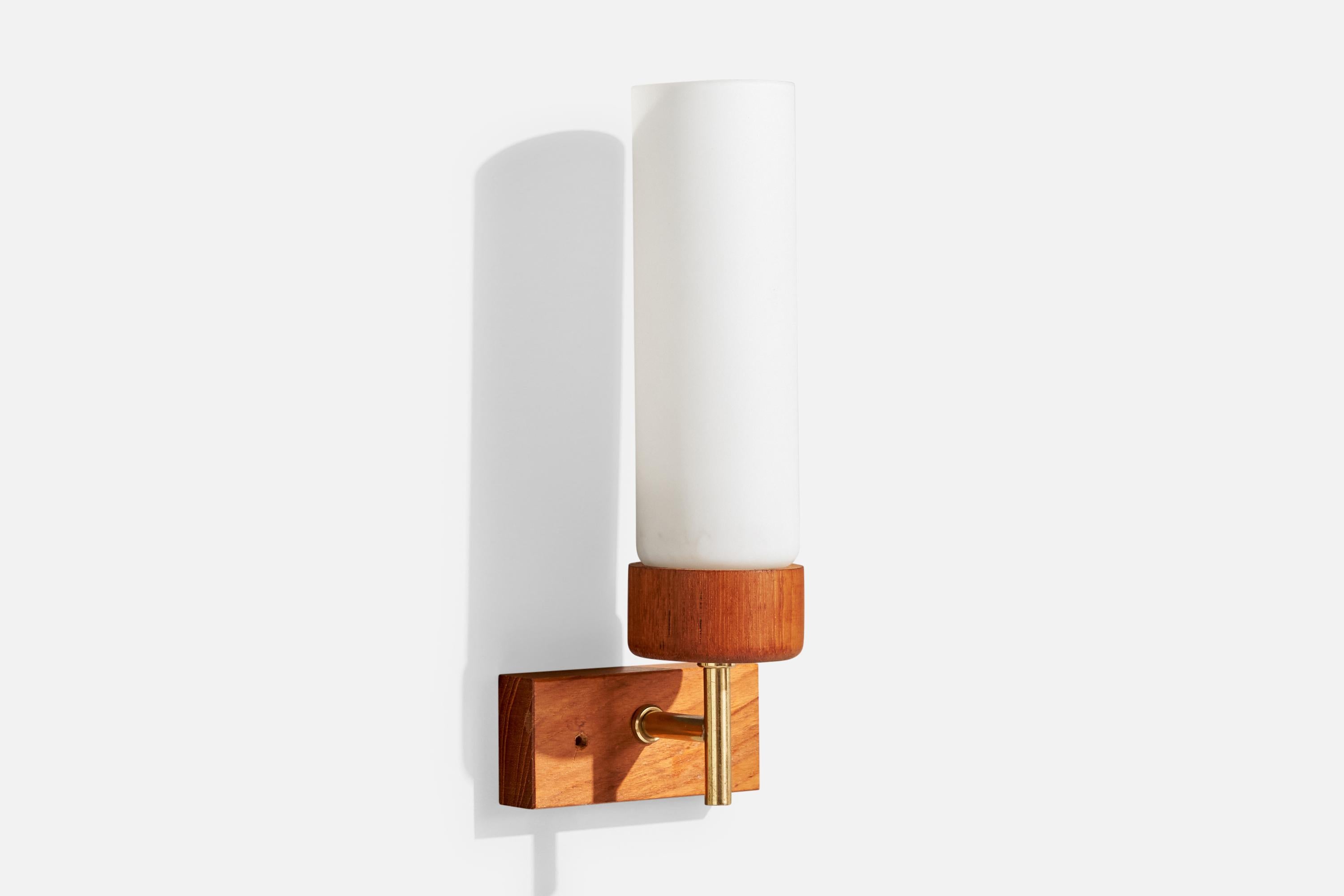 A brass, teak and white opaline glass wall light designed and produced in Sweden, c. 1950s.

Overall Dimensions (Inches): 10” H x 4” W x 3.6“ D

Back Plate Dimensions (Inches): 1.875” H x 4“ W x .9” D

Bulb Specifications: E-14

Number of Sockets