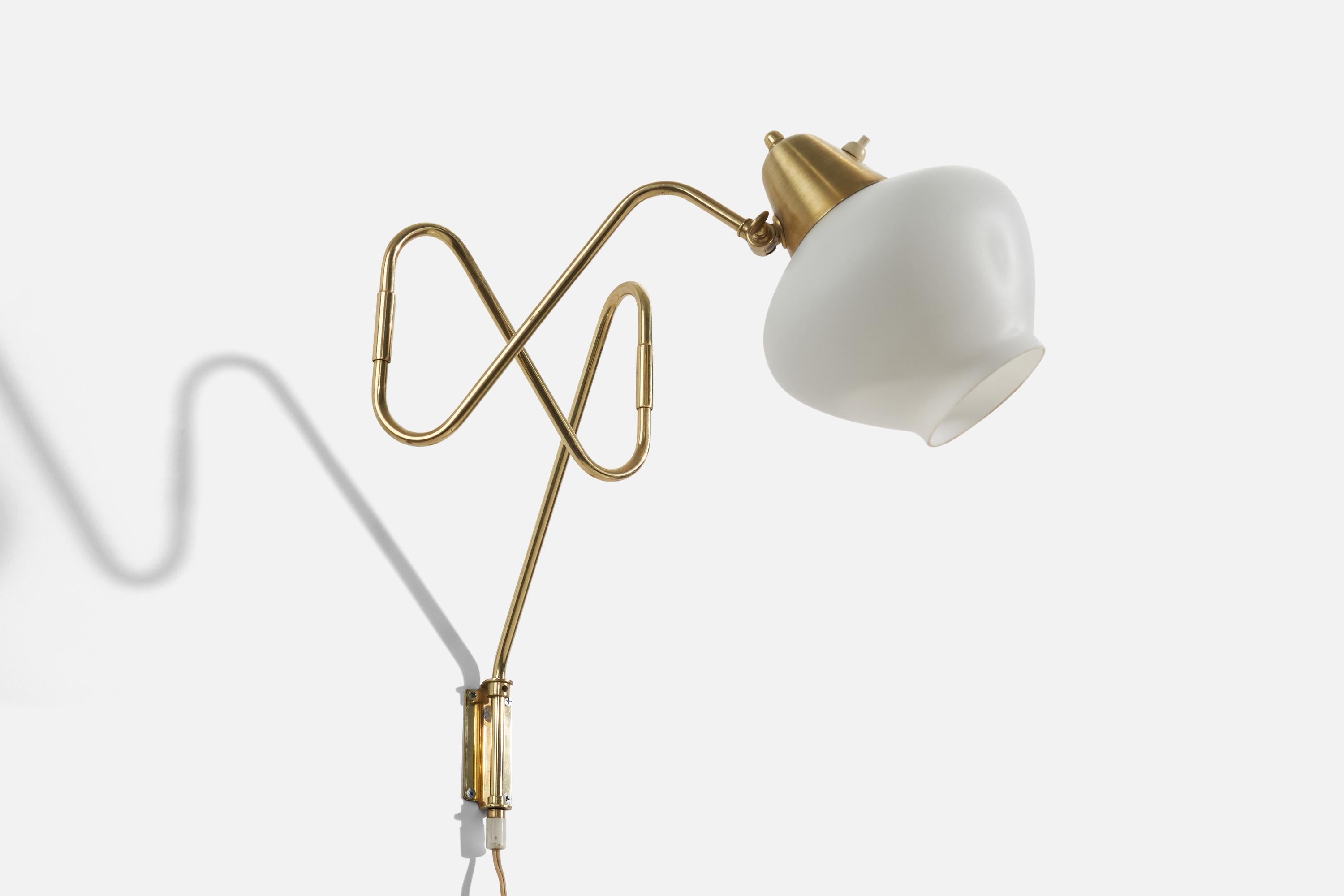 A brass and white glass wall light, designed and produced by a Swedish designer, Sweden, 1970s.