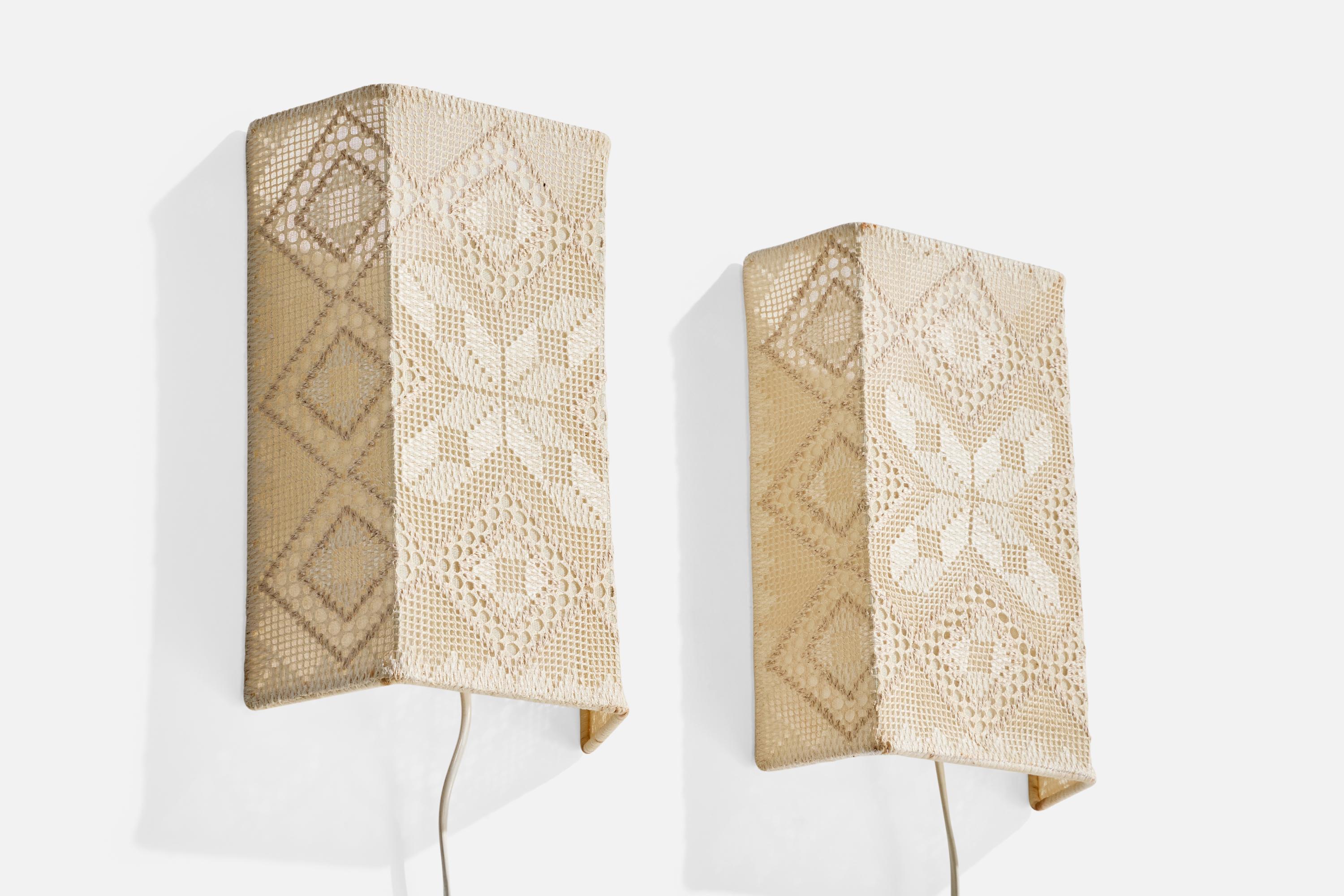 A pair of off-white embroidery fabric wall lights designed and produced in Sweden, c. 1960s.

Overall Dimensions (inches): 11.125