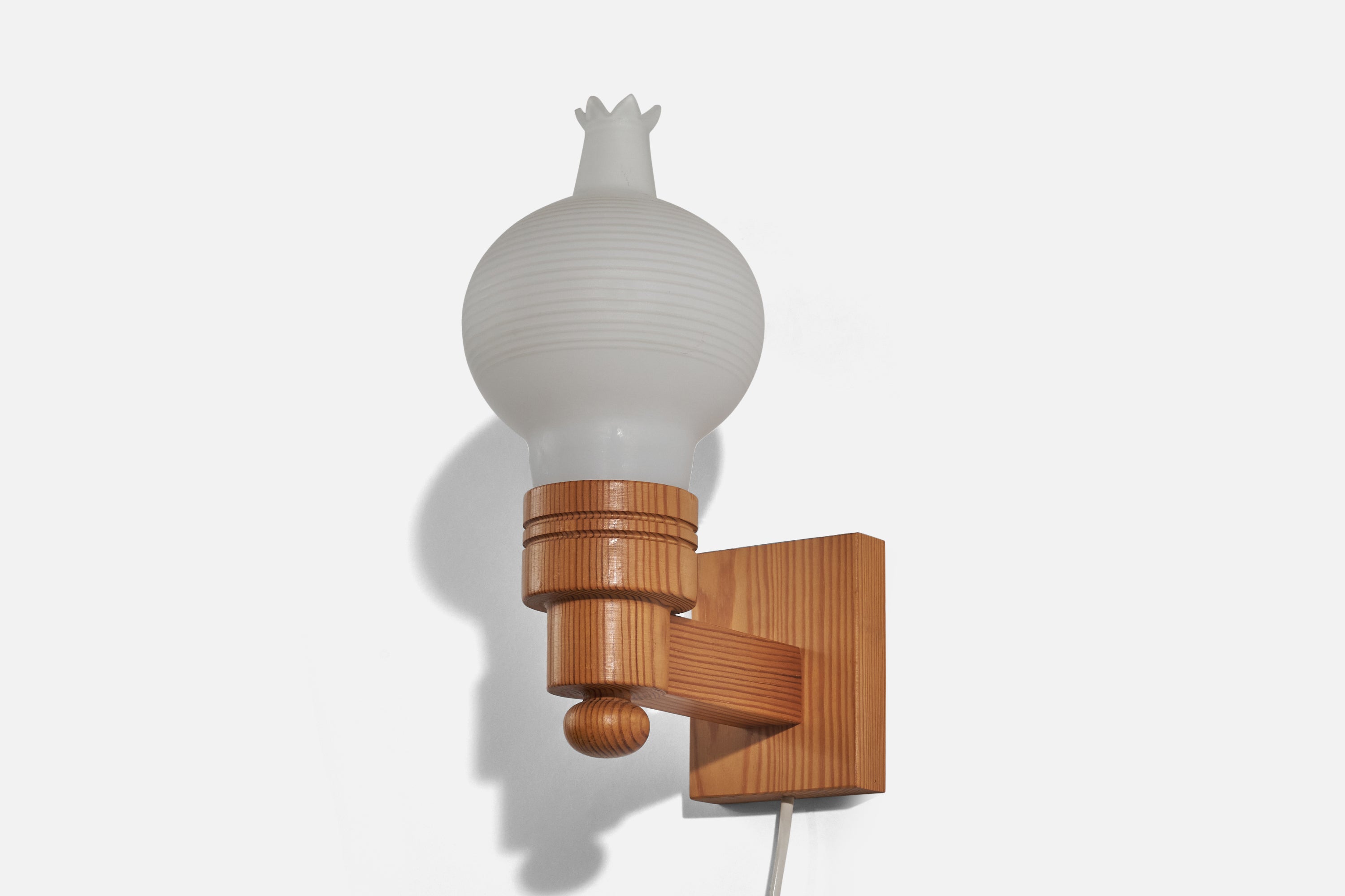 A pine and milk glass wall light designed in Sweden, c. 1970s. 

