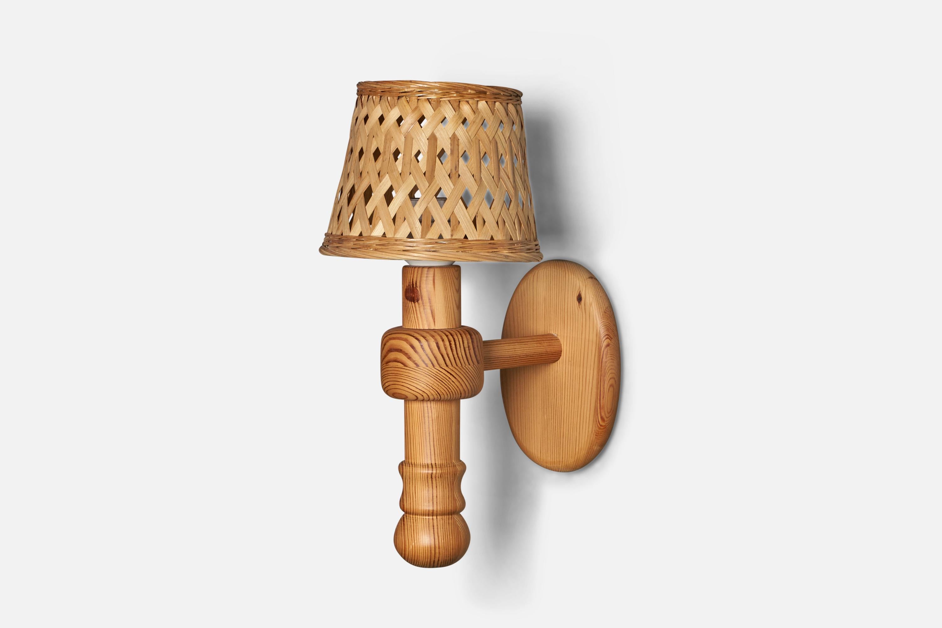 A sizeable pine and rattan wall light designed and produced in Sweden, 1970s.

Overall Dimensions (inches): 16