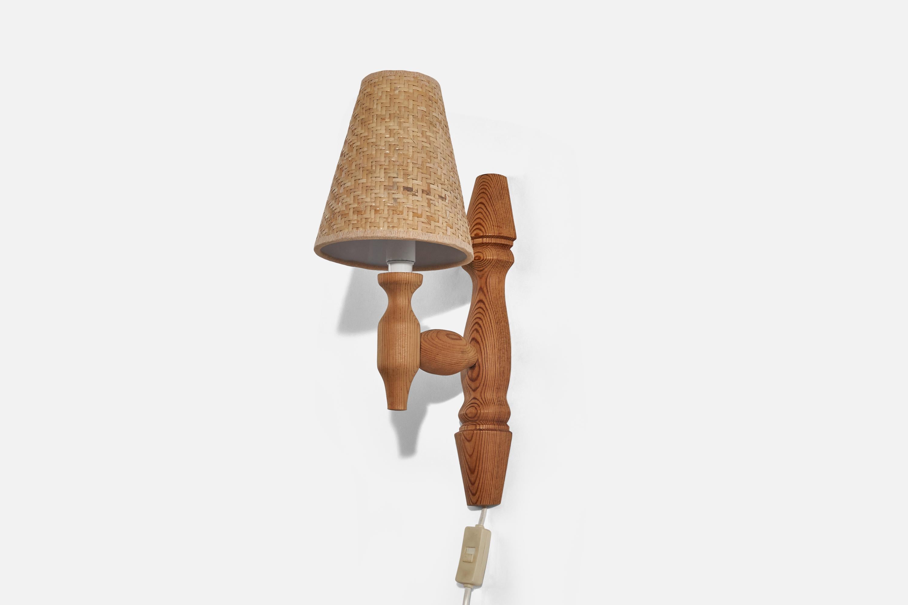 A pine and rattan wall light designed in Sweden, c. 1970s. 

Dimensions of back plate (inches) : 13 x 2.56 x 1.18 (H x W x D)
Lampshade can be purchased with the lamp.