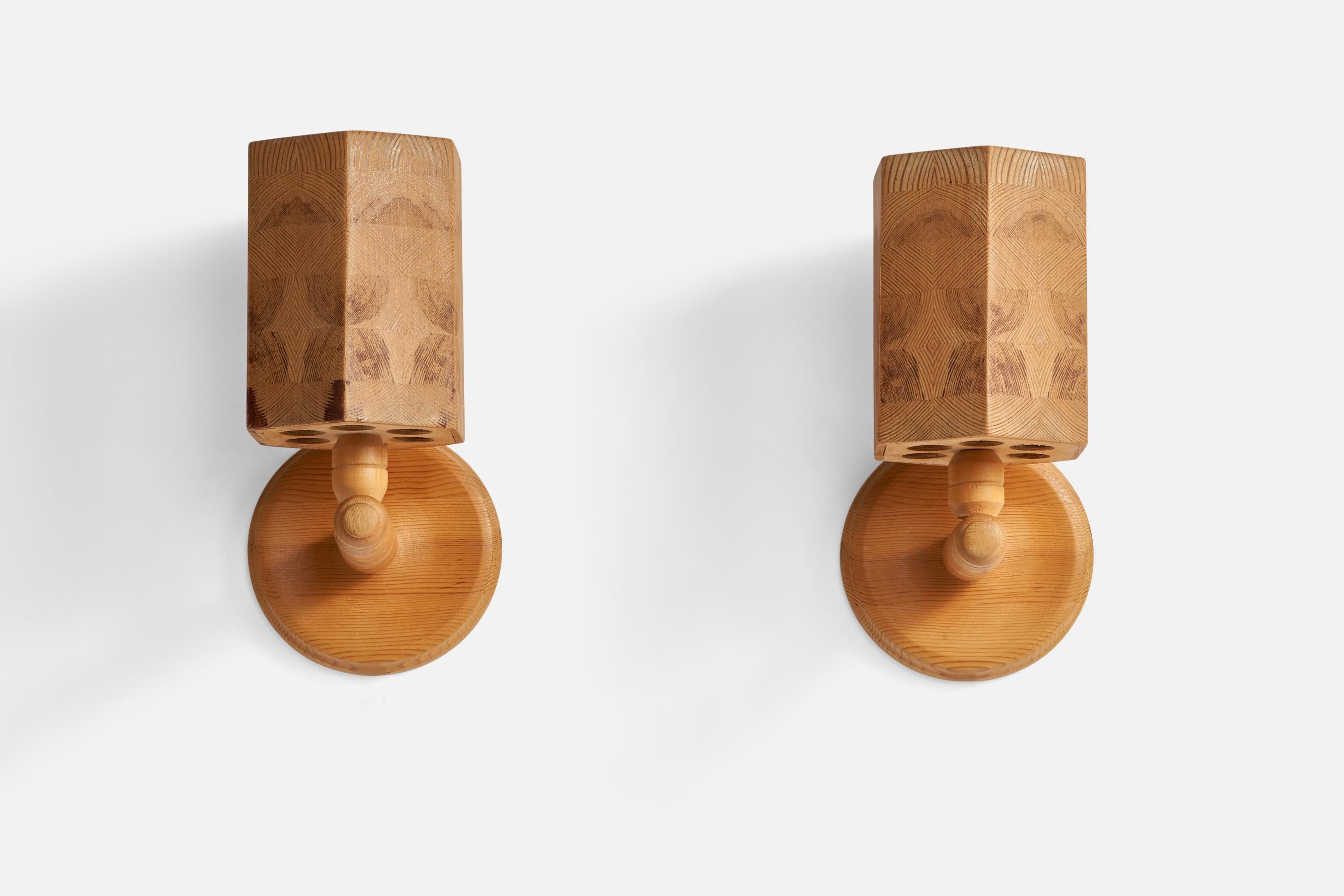 A pair of pine wall lights designed and produced in Sweden, c. 1970s.

Overall Dimensions (inches): 11.6” H x 5.9” W x 6.5” D
Back Plate Dimensions (inches): 5.93” Diameter x 0.75” Depth
Bulb Specifications: E-14 Bulbs
Number of Sockets: 2
All