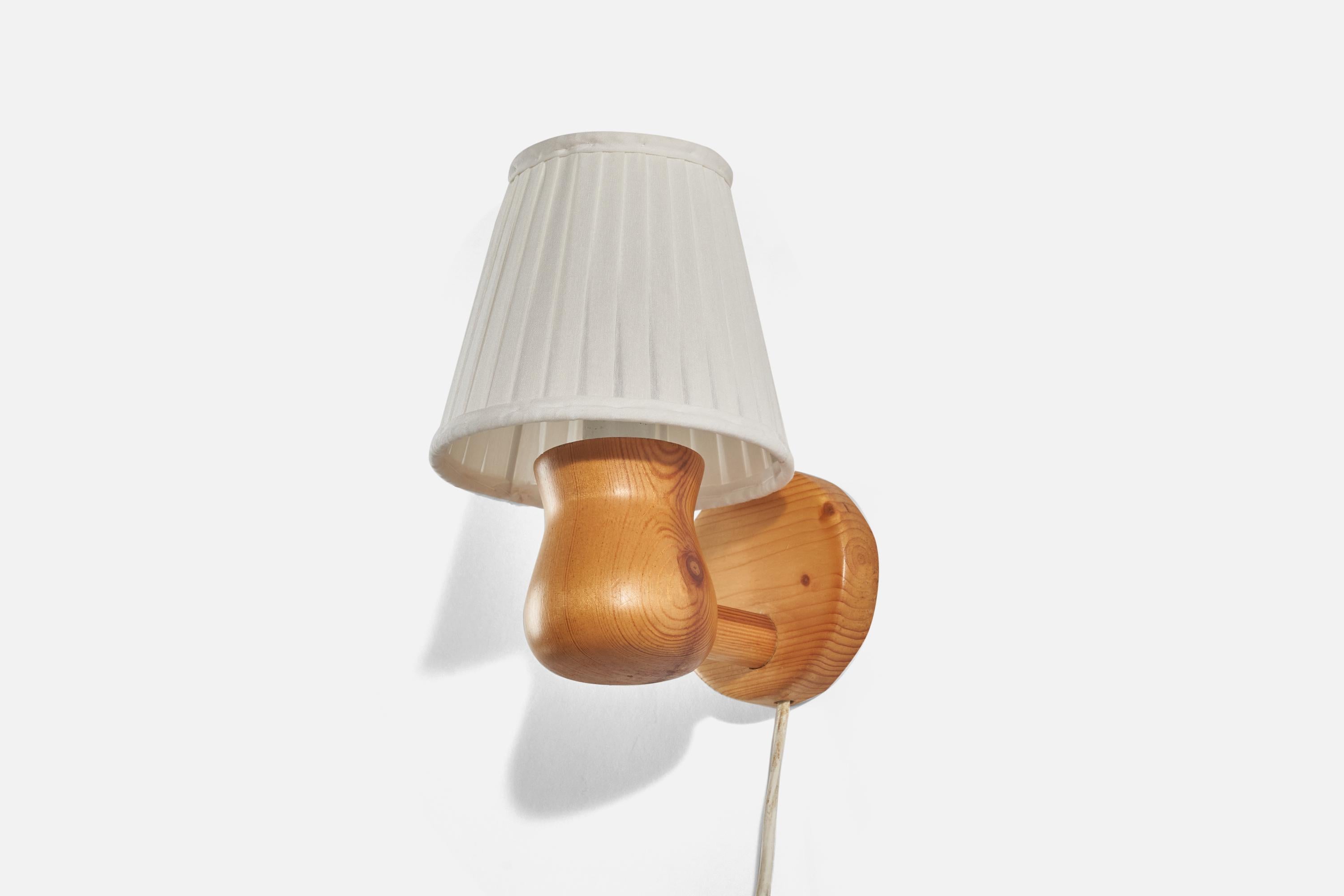 A pine and white fabric wall light designed and produced in Sweden, 1970s.

Sold with Lampshade. Dimensions stated are of Sconce with Shade(s).

Dimensions of Back Plate (inches) : 3.62 x 3.62 x 0.87 (Height x Width x Depth).

Socket takes
