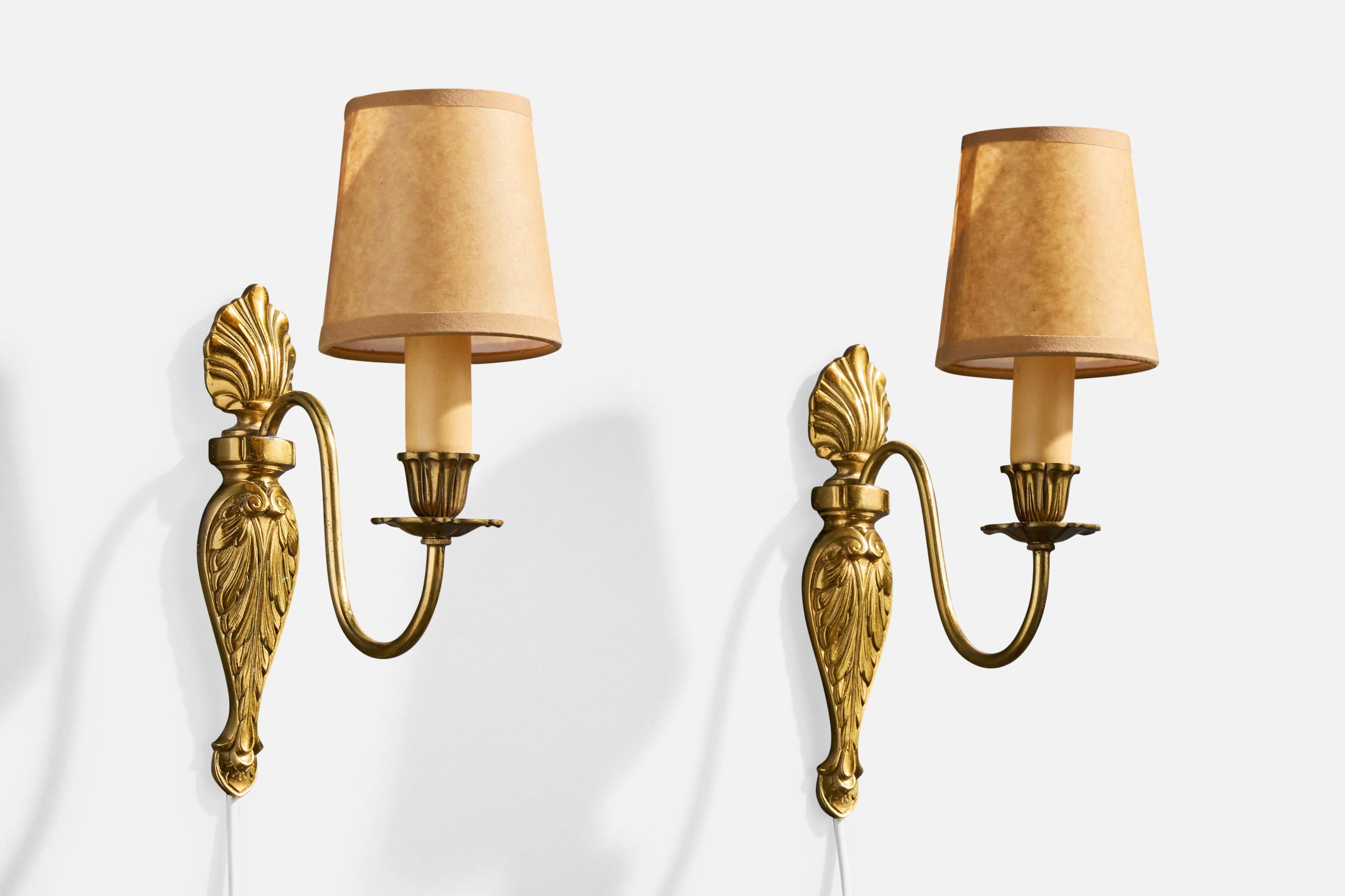 A pair of brass, bakelite and brown parchment paper wall lights designed and produced in Sweden, c. 1940s.

Brass presents with very light oxidation. 

Overall Dimensions (Inches): 11.0