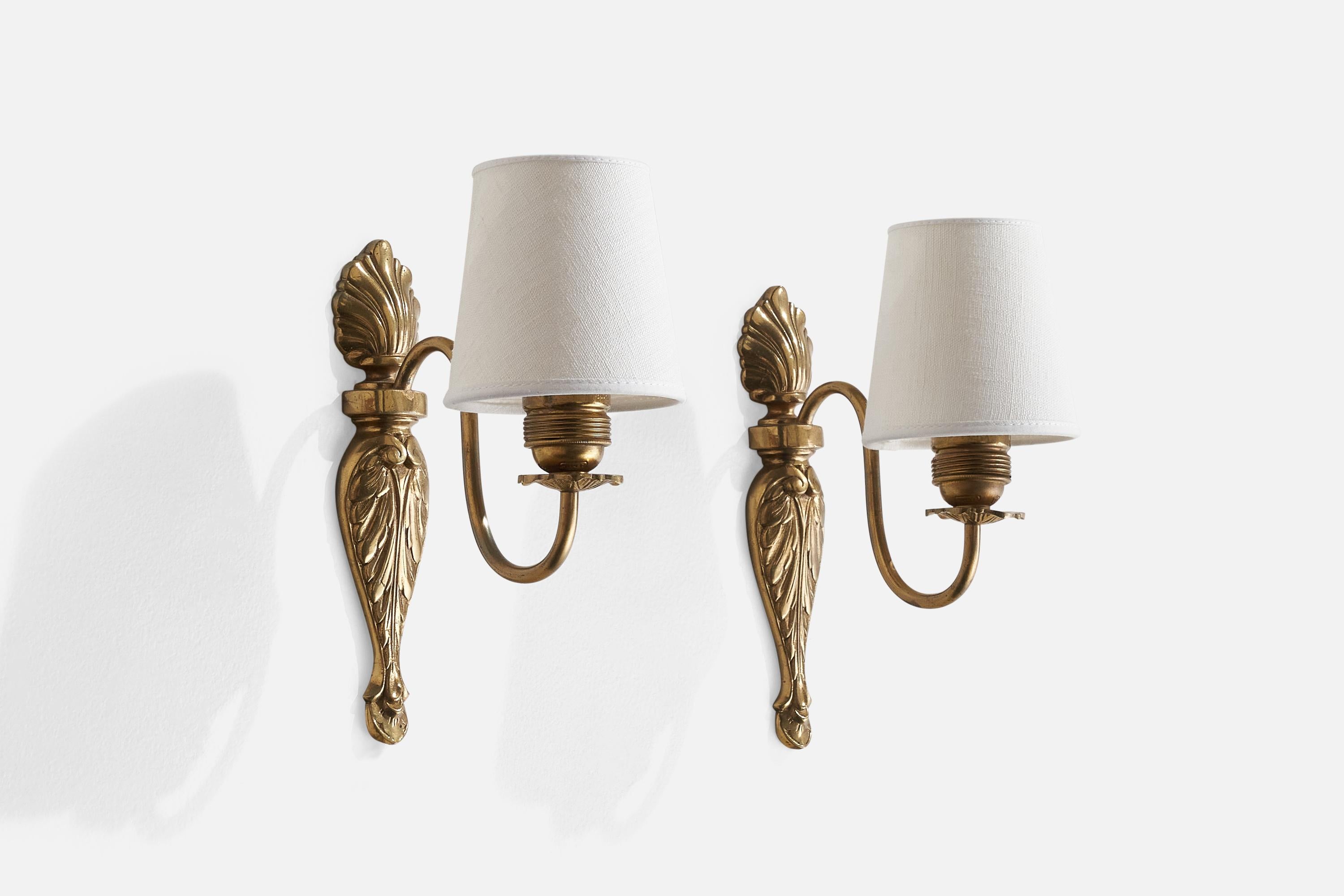 A pair of brass and white fabric wall light designed and produced in Sweden, c. 1930s.

Overall Dimensions (inches): 9” H x 4” W x 6.5 D
Back Plate Dimensions (inches): n/a
Bulb Specifications: E-26 Bulb
Number of Sockets: 2
All lighting will be
