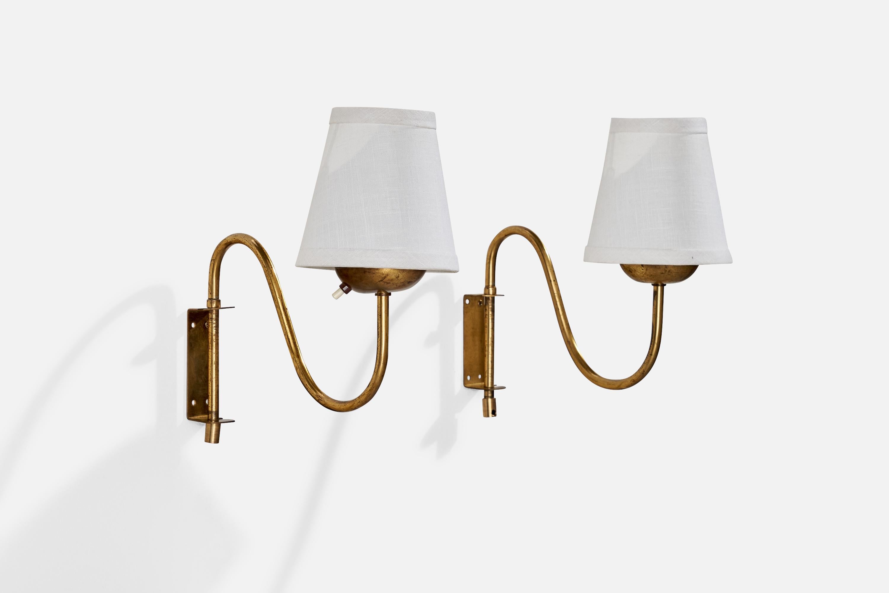 A pair of adjustable brass and white fabric wall lights designed and produced in Sweden, c. 1940s.

Configured for plug in with cord feeding from bottom of stem.

Overall Dimensions (inches): 12” H x 5.09” W x 11.5” D
Back Plate Dimensions (inches):