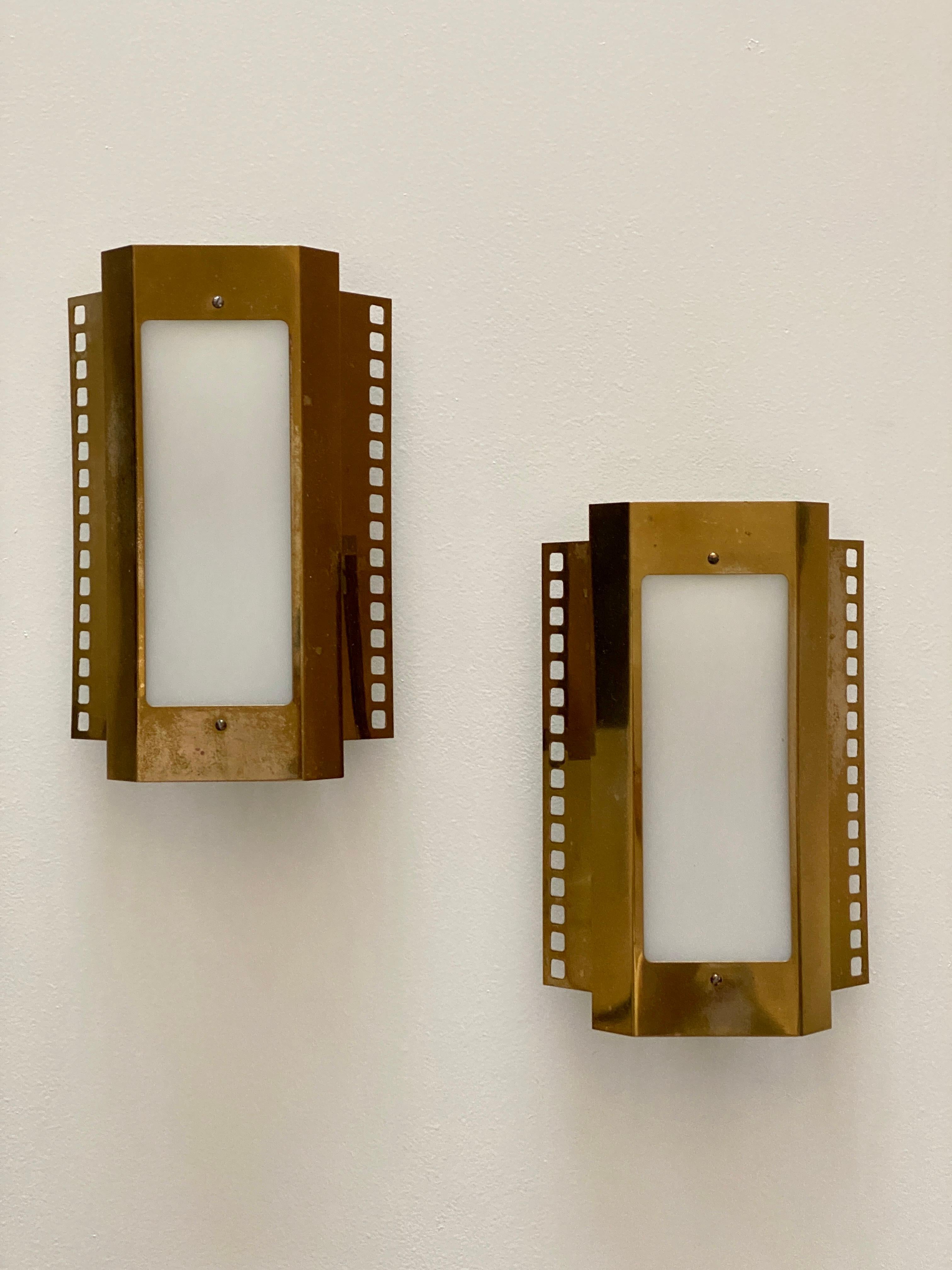 A pair of modernist wall lamps / lights / sconces. Designed and produced in Sweden, circa 1960s.

Features brass finished metal, and original glass. Features period markings indicating it's of Swedish production.

Other designers of the period