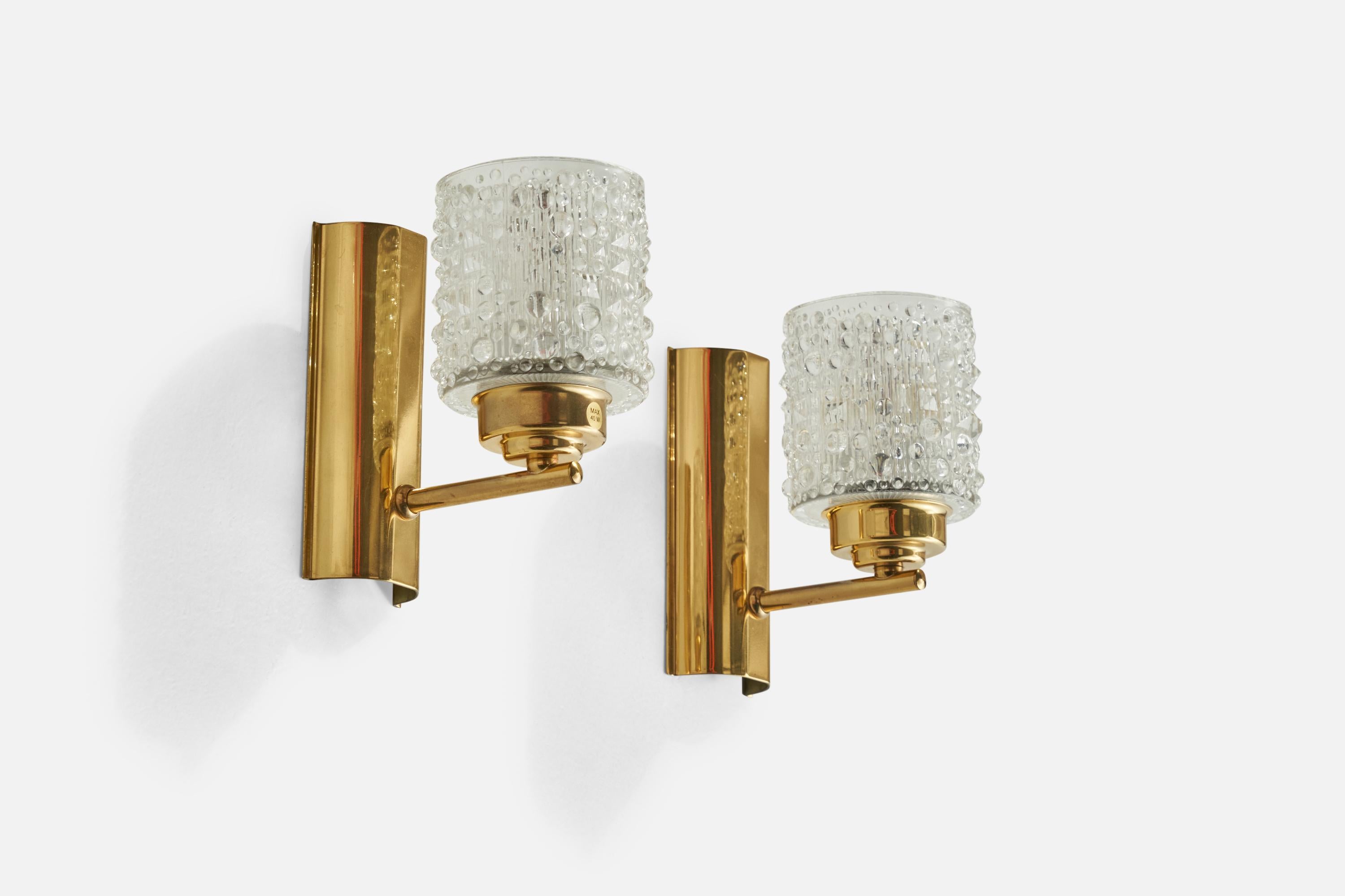 A pair of brass and glass wall lights designed and produced in Sweden, c. 1960s.

Overall Dimensions (inches): 6.25” H x 3.5” W x 5.6” D
Back Plate Dimensions (inches): 5.9” H x 2.62” W x 1.1” D
Bulb Specifications: E-14 Bulbs
Number of Sockets:
