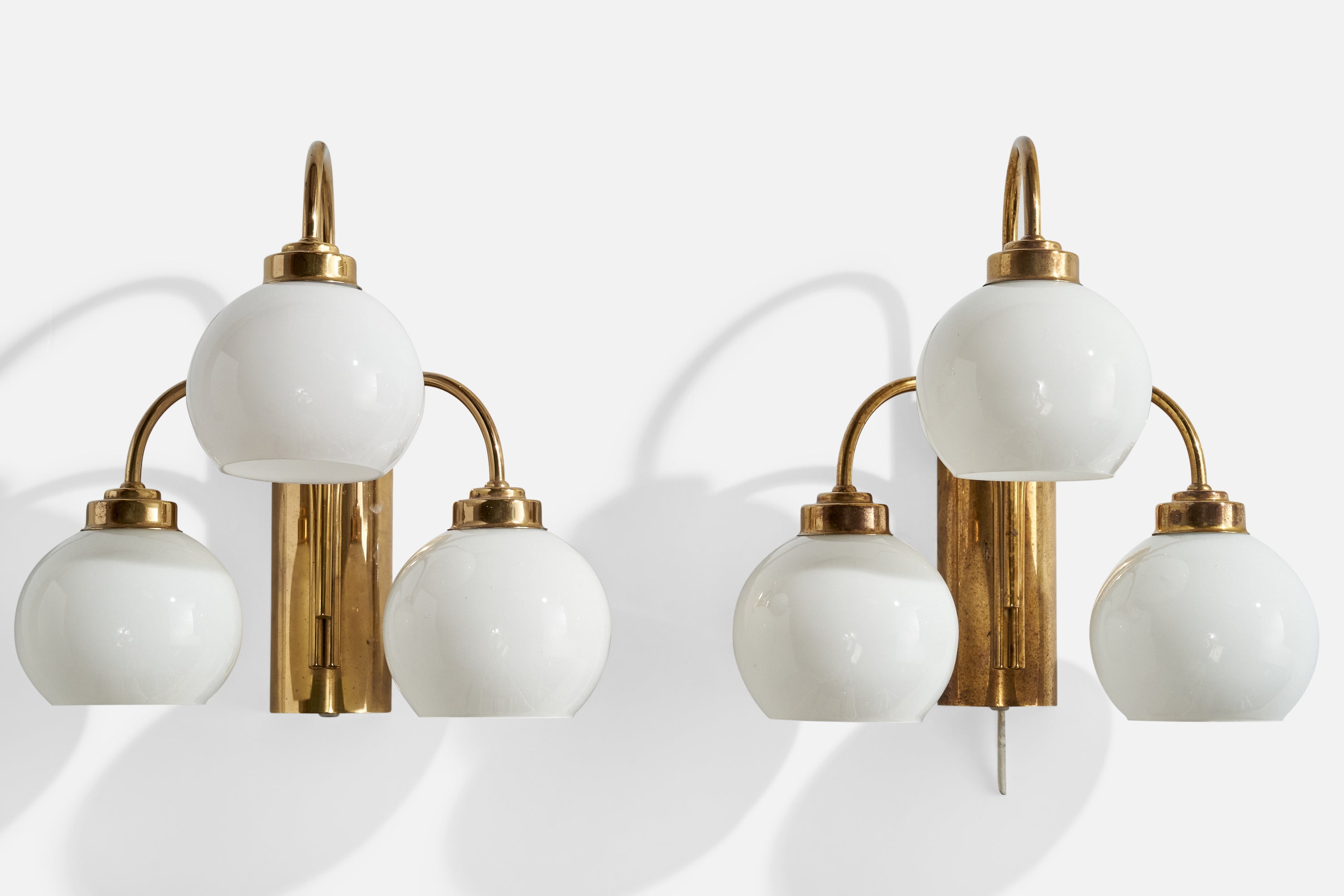 A pair of brass and opaline glass wall lights designed and produced in Sweden, c 1960s.

Overall Dimensions (inches):  13.25” H x  13” W x  9.25“D

Back Plate Dimensions (Inches):  7.875” H x 3” W x 1.5” D

Bulb Specifications: E-26 Bulbs

Number of