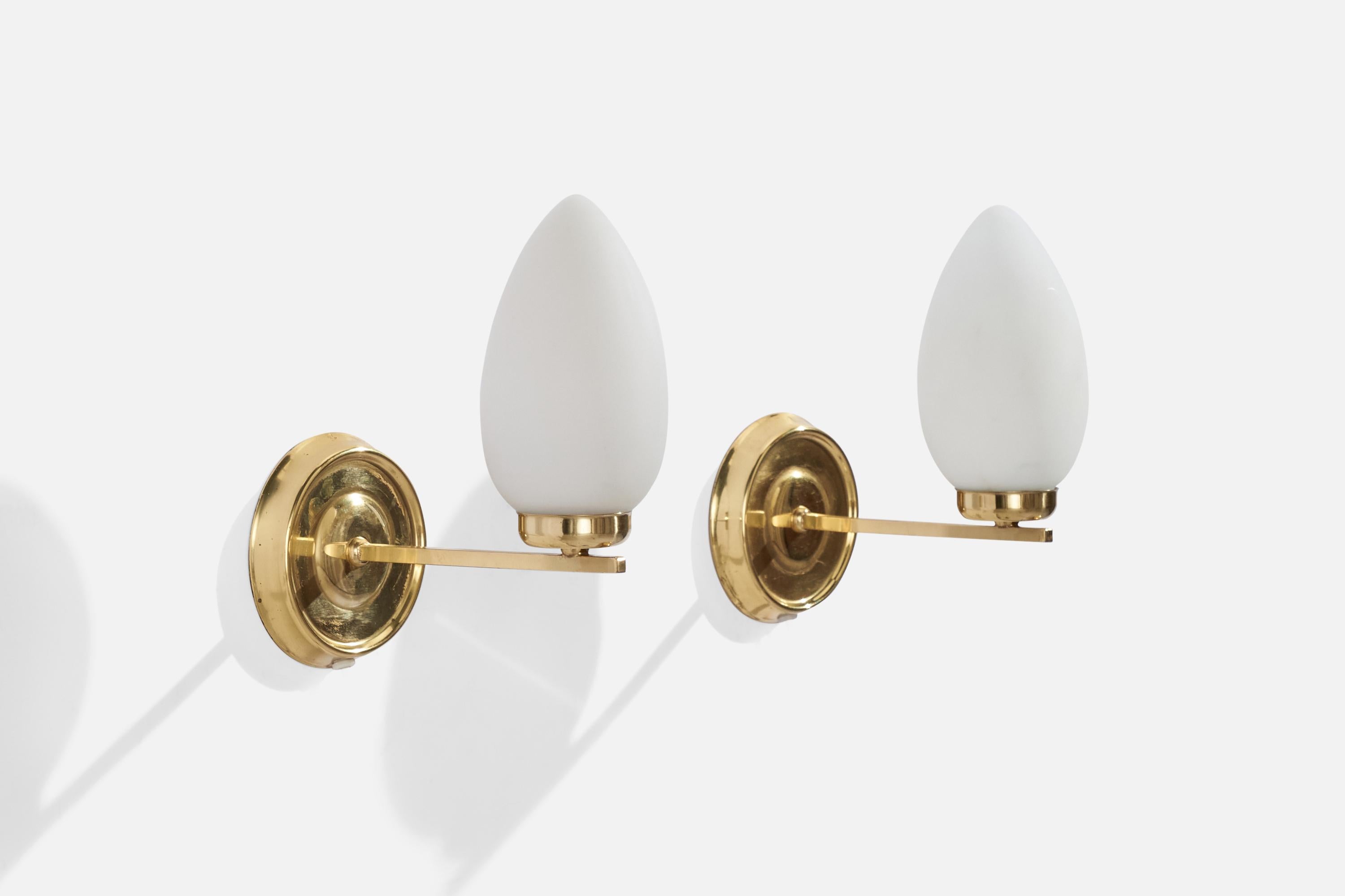 A pair of brass and opaline glass wall lights designed and produced in Sweden, c. 1970s.

Overall Dimensions (inches): 7.5” H x 4.55” W x 8” D
Back Plate Dimensions (inches): 4.46” H x 1” D
Bulb Specifications: E-14 Bulb
Number of Sockets: 2
All