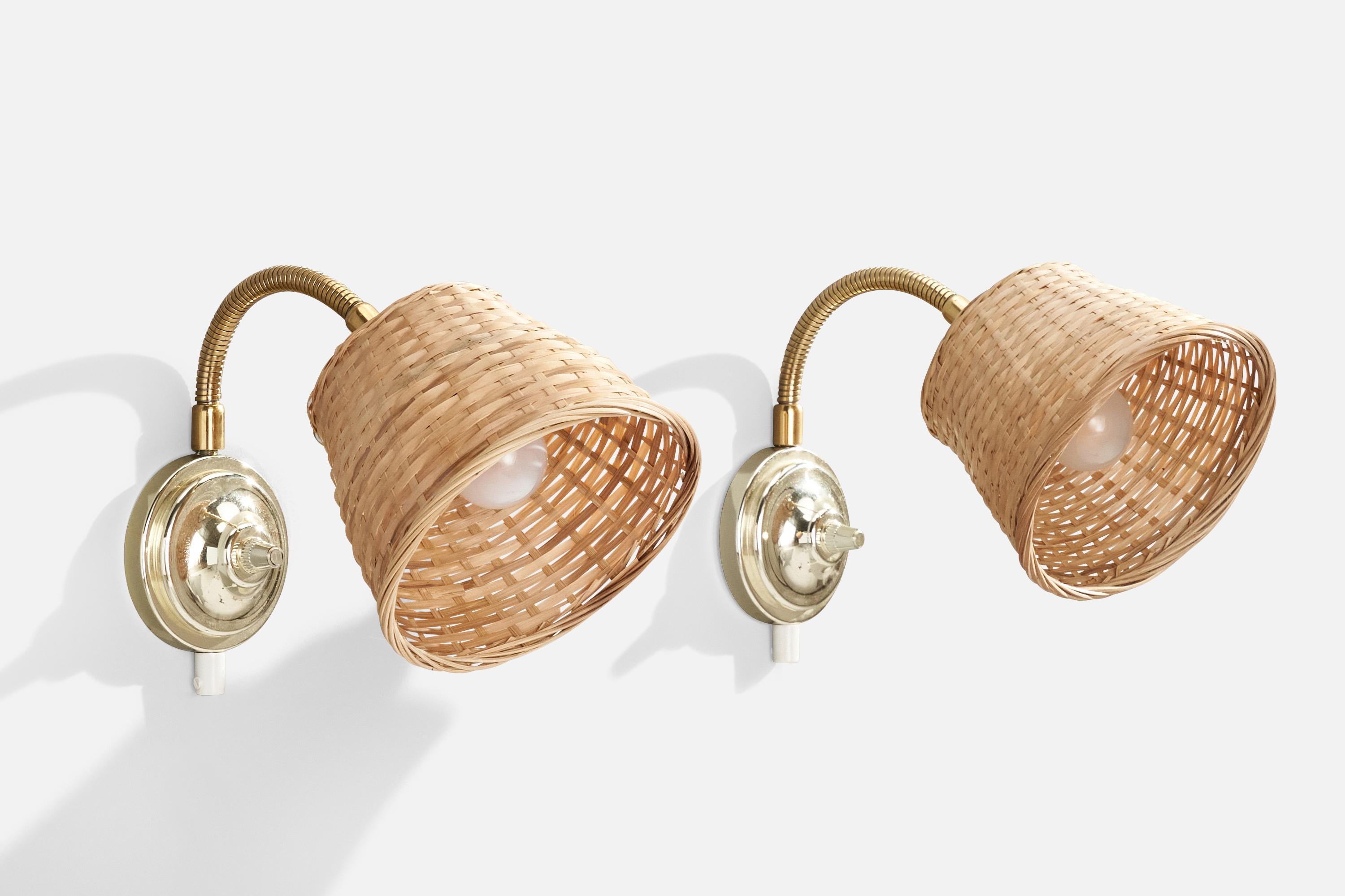 A pair of brass, metal and rattan wall lights designed and produced in Sweden, 1970s.

Overall Dimensions (inches): 18”  H x 5.5”  W x 7”  D
Back Plate Dimensions (inches): 4” H x 4” W x 2.5 D
Bulb Specifications: E-14 Bulb
Number of Sockets: 2
All