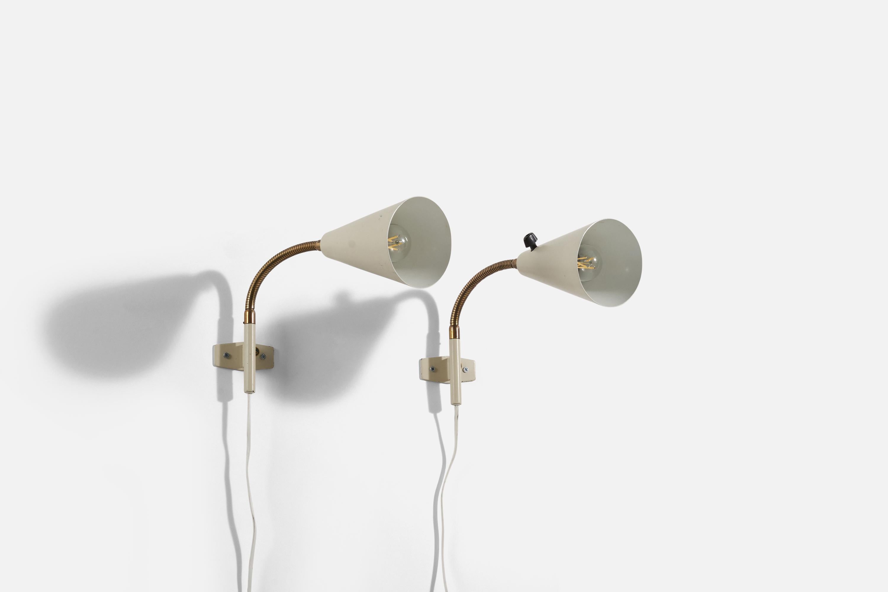 A pair of brass and metal wall lights produced by a Swedish designer, Sweden, 1960s.
