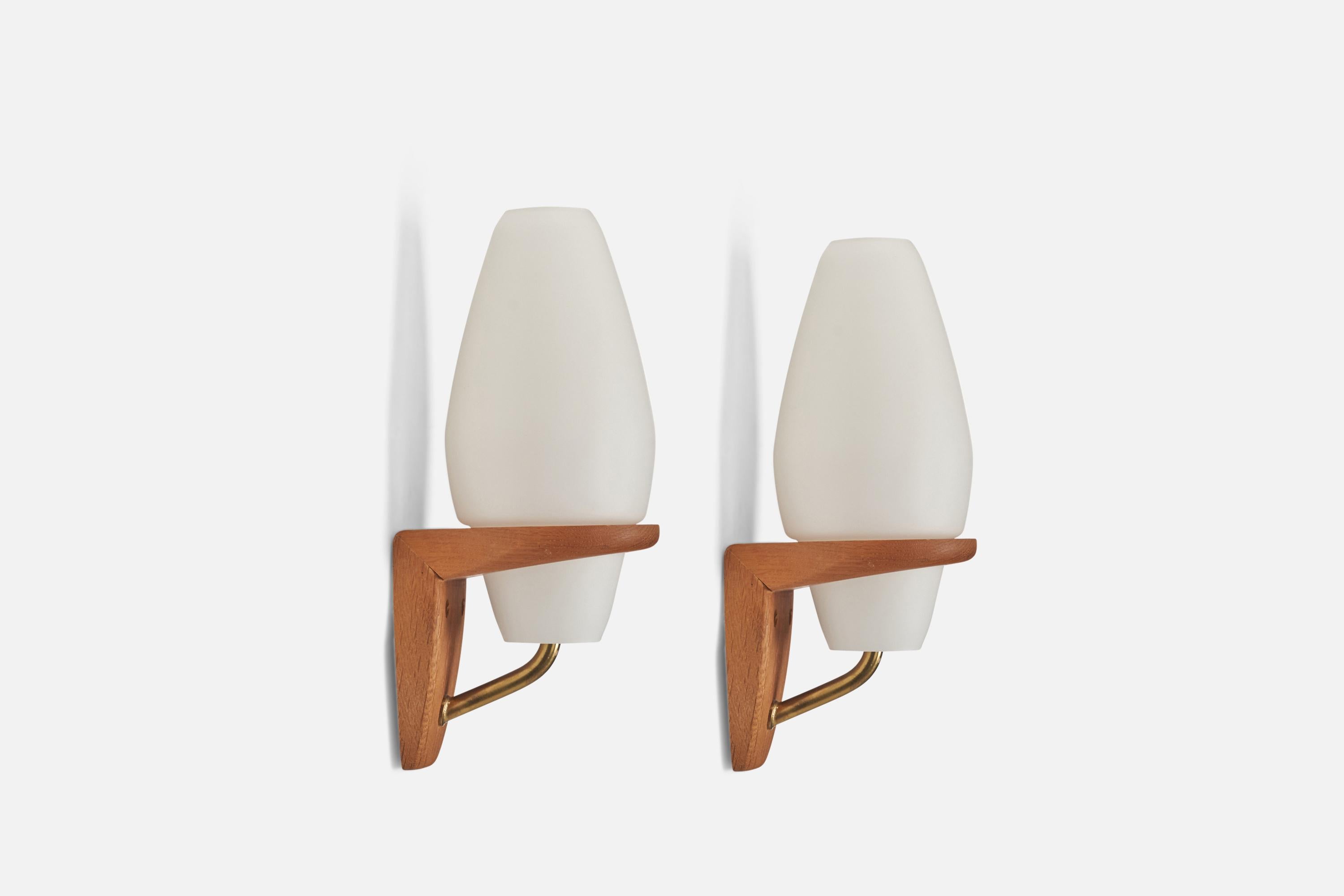A pair of brass, oak and milk glass wall lights designed and produced by a Swedish Designer, Sweden, 1950s.