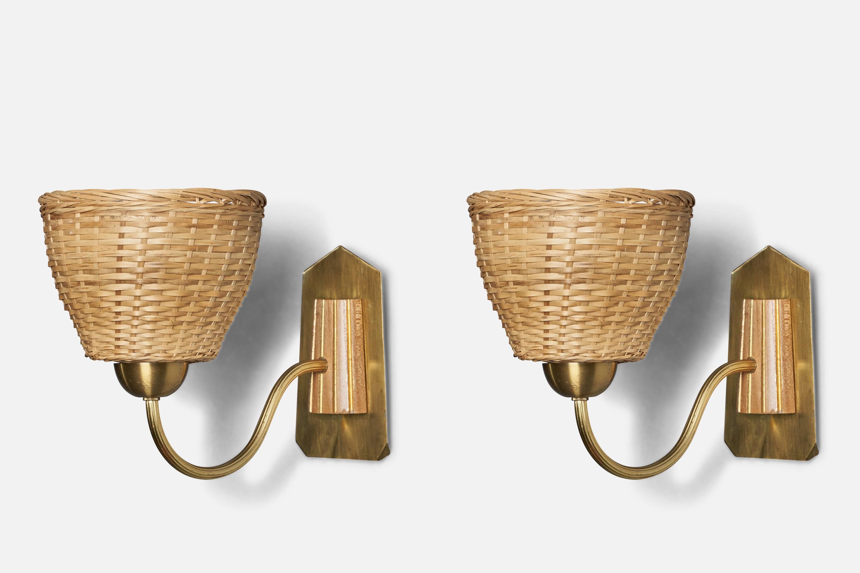 A pair of brass, oak and rattan wall lights designed and produced in Sweden, c. 1970s.

Overall Dimensions (inches): 8” H x 6.9” W x 11” D
Bulb Specifications: E-14 Bulb
Number of Sockets: 1
