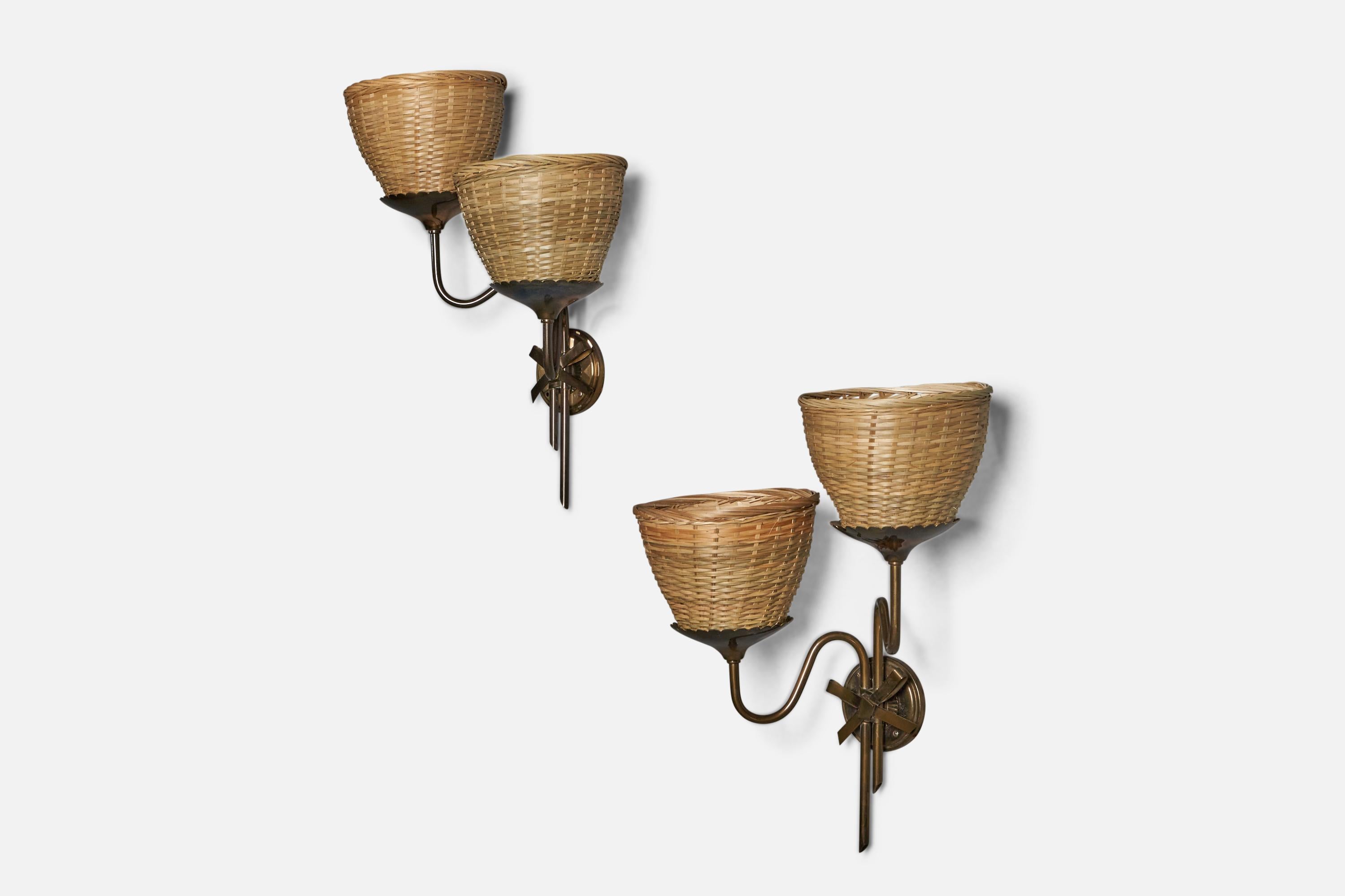 A pair of two-armed organic brass and rattan wall lights, designed and produced in Sweden, c. 1940s.

Overall Dimensions (inches): 19” H x 15” W x 9” D
Back Plate Dimensions (inches): 3.75” Diameter x 0.5” D
Bulb Specifications: E-26 Bulb
Number of