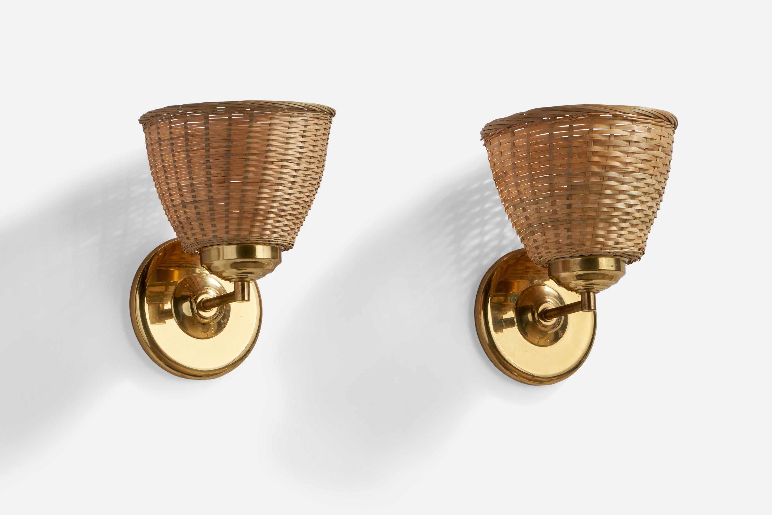 A pair of brass and rattan wall lights designed and produced in Sweden, c. 1960s.

Overall Dimensions (inches): 8.75” H x 7.15” W x 7” D
Back Plate Dimensions (inches): 5.05” Diameter x 0.8” Depth
Bulb Specifications: E-26 Bulbs
Number of Sockets: