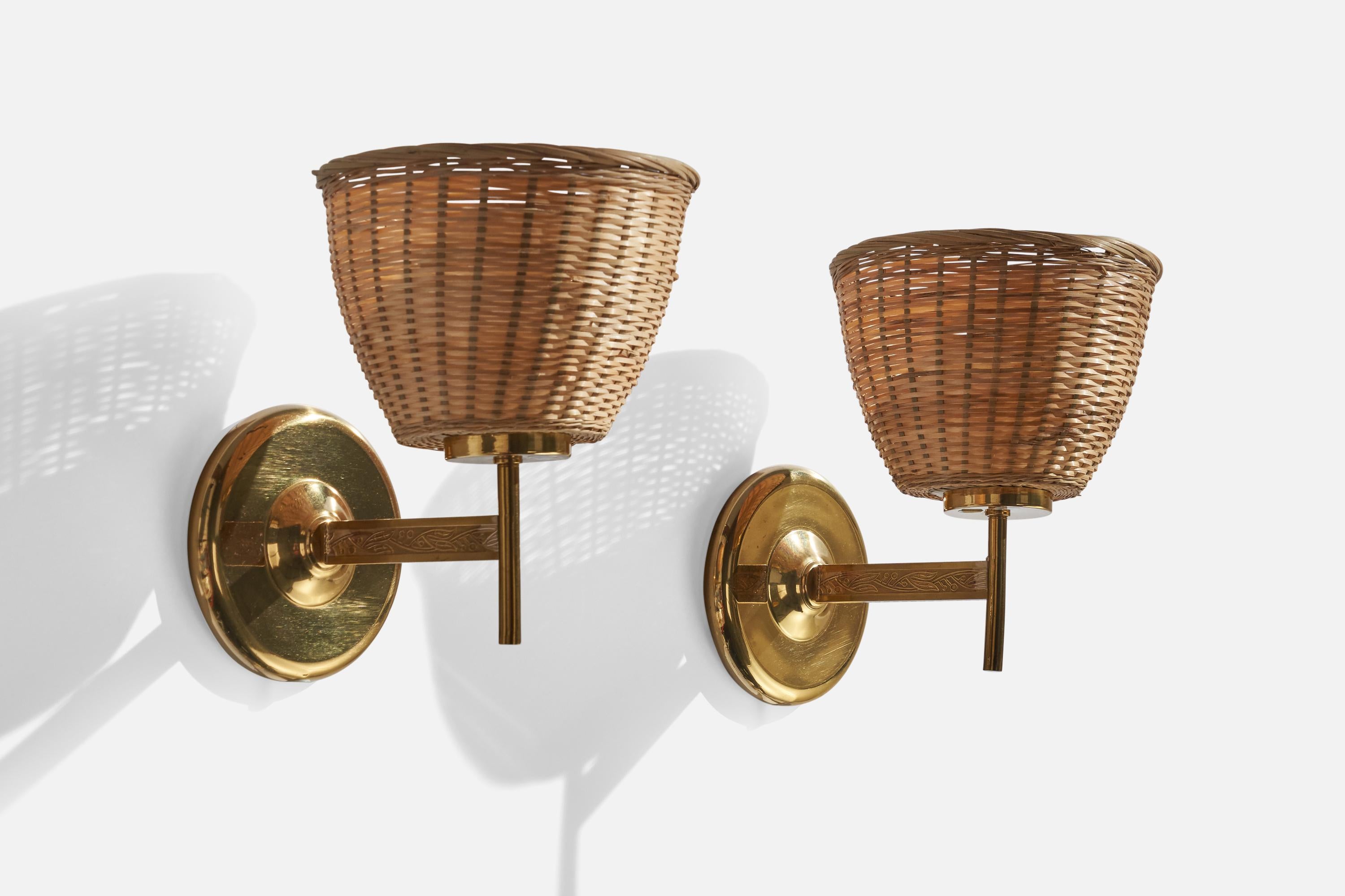 A pair of brass and rattan wall lights designed and produced in Sweden, c. 1960s.

Overall Dimensions (inches): 9”  H x 7” W x 8.5” D
Back Plate Dimensions (inches): 5”  H x 5”  W x .75 D
Bulb Specifications: E-26 Bulb
Number of Sockets: 2
All