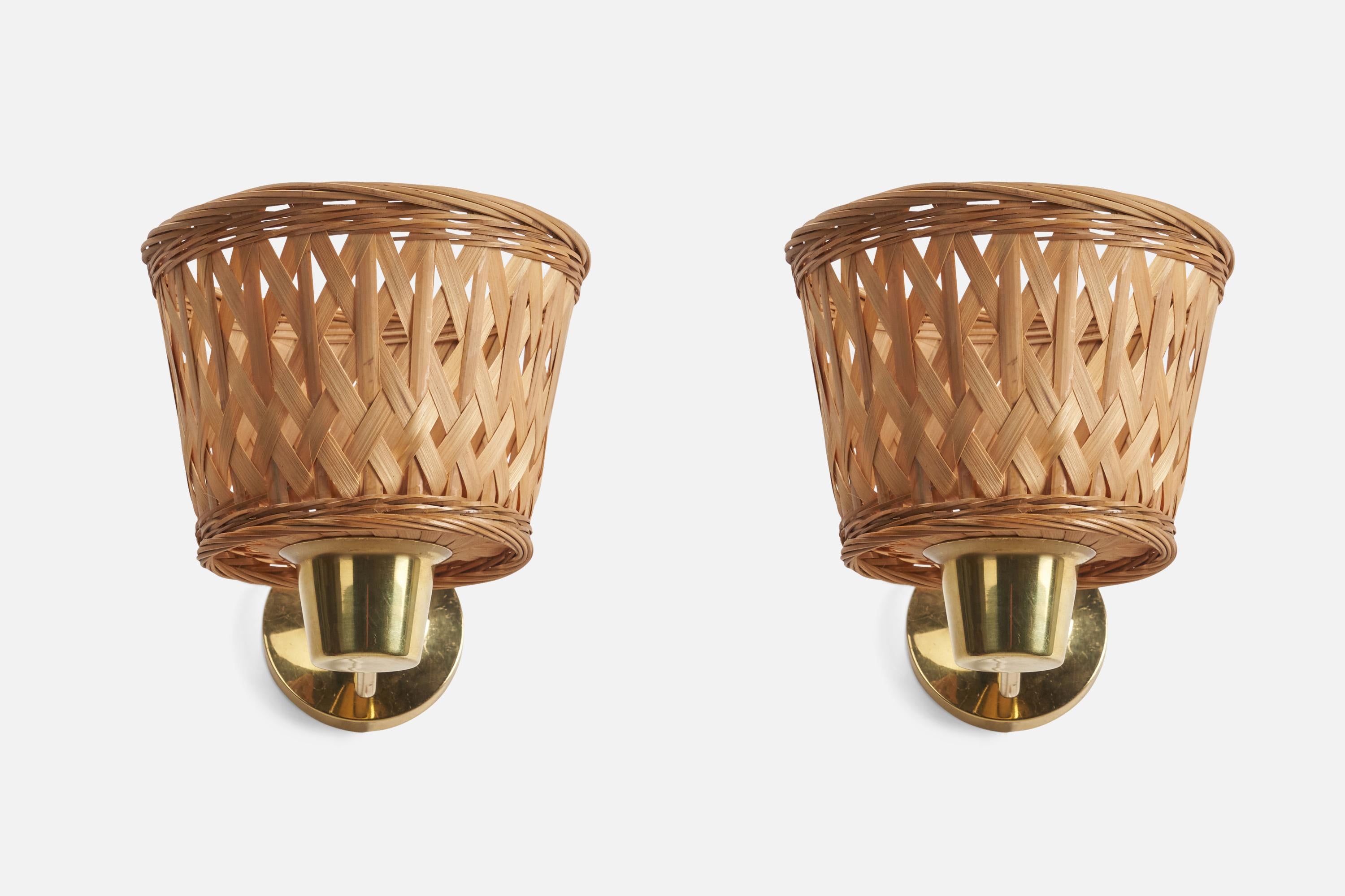 A pair of brass and rattan wall lights designed and produced by a Swedish Designer, Sweden, 1970s.

Dimensions of Back Plate (inches) : 3.5 x 3.5 x 0.9 (Height x Width x Depth)

Sockets take E-14 bulbs.

There is no maximum wattage stated on
