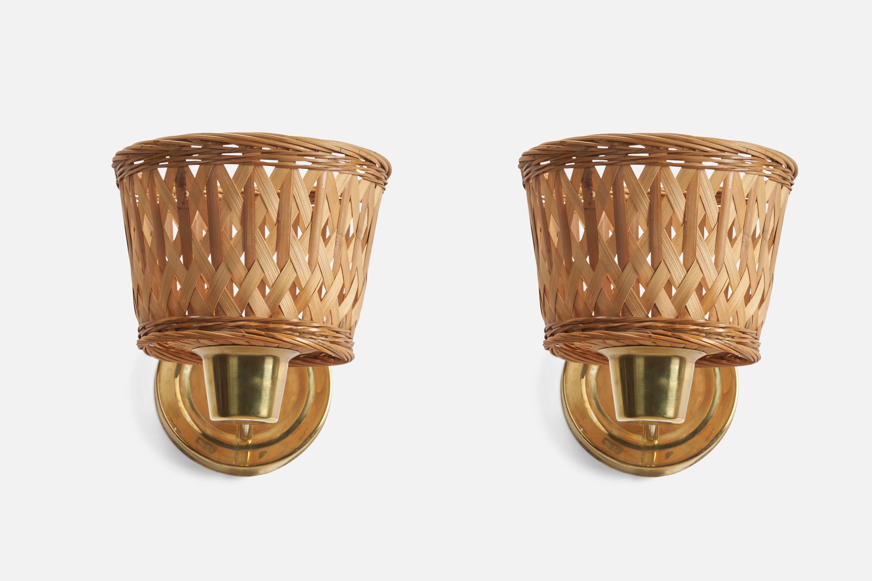 A pair of brass and rattan wall lights designed and produced by a Swedish Designer, Sweden, 1970s.

Dimensions of Back Plate (inches) : 5.1 x 5.1 x 0.7 (Height x Width x Depth)

Sockets take E-14 bulbs.

There is no maximum wattage stated on