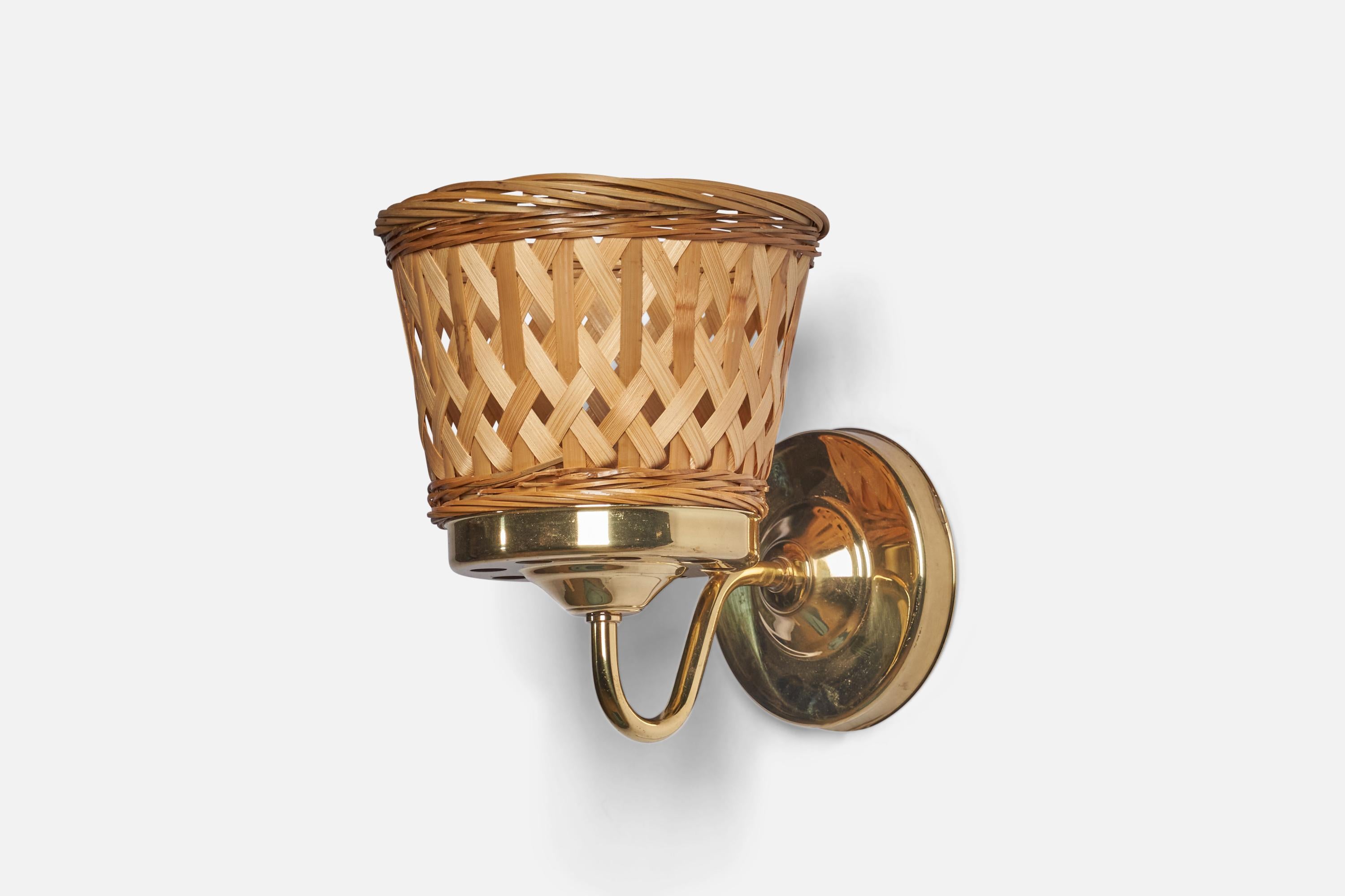 A pair of brass and rattan wall lights, designed and produced in Sweden, c. 1970s.

Overall Dimensions: 7.75