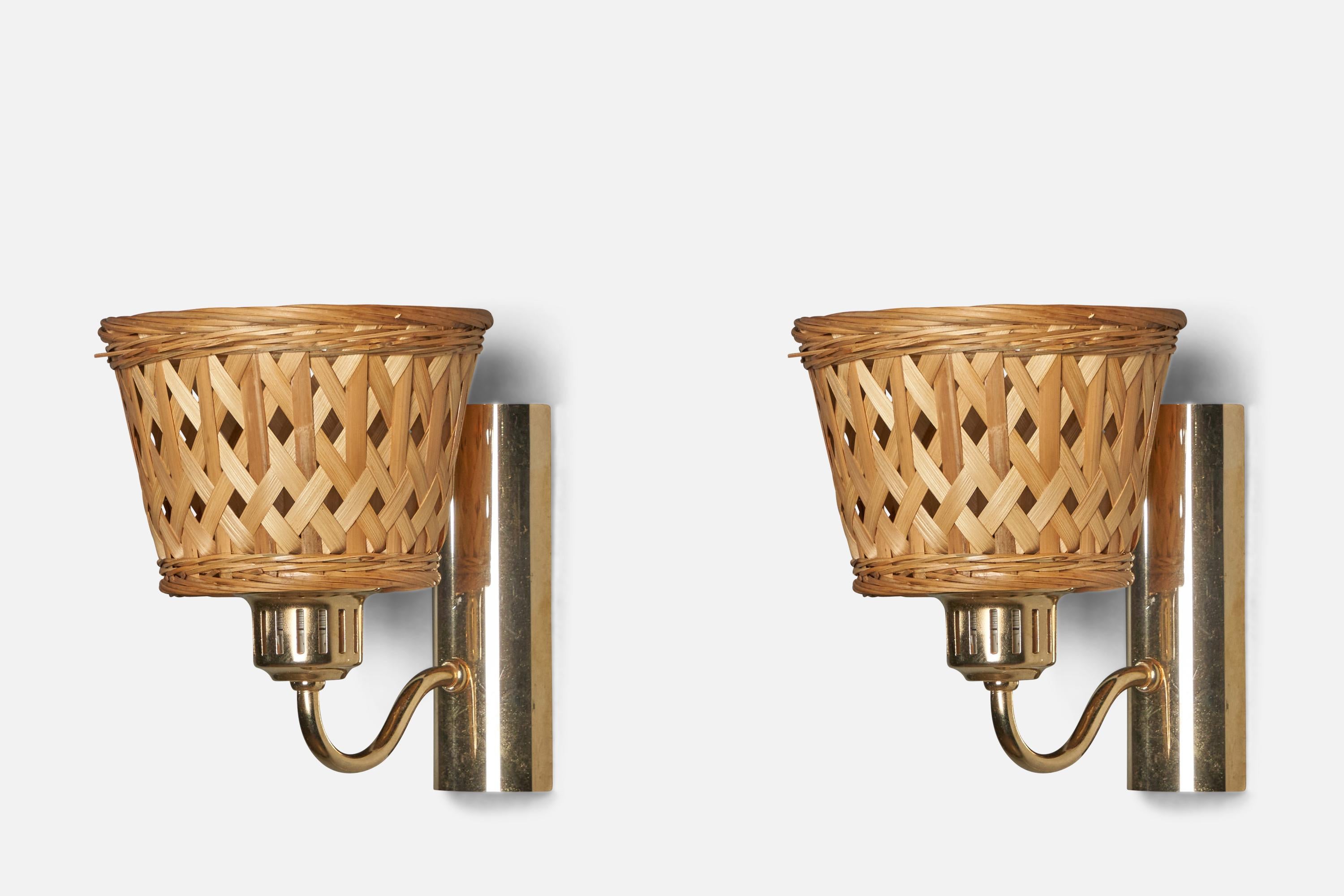 A pair of brass and rattan wall lights designed and produced in Sweden, c. 1970s.

Overall Dimensions (inches): 7.75” H x 6.5” W x 7.75” D

Back Plate Dimensions (inches): 6.5” H x 2.3” W x 1.5” D

Bulb Specifications: E-26 Bulb

Number of Sockets: