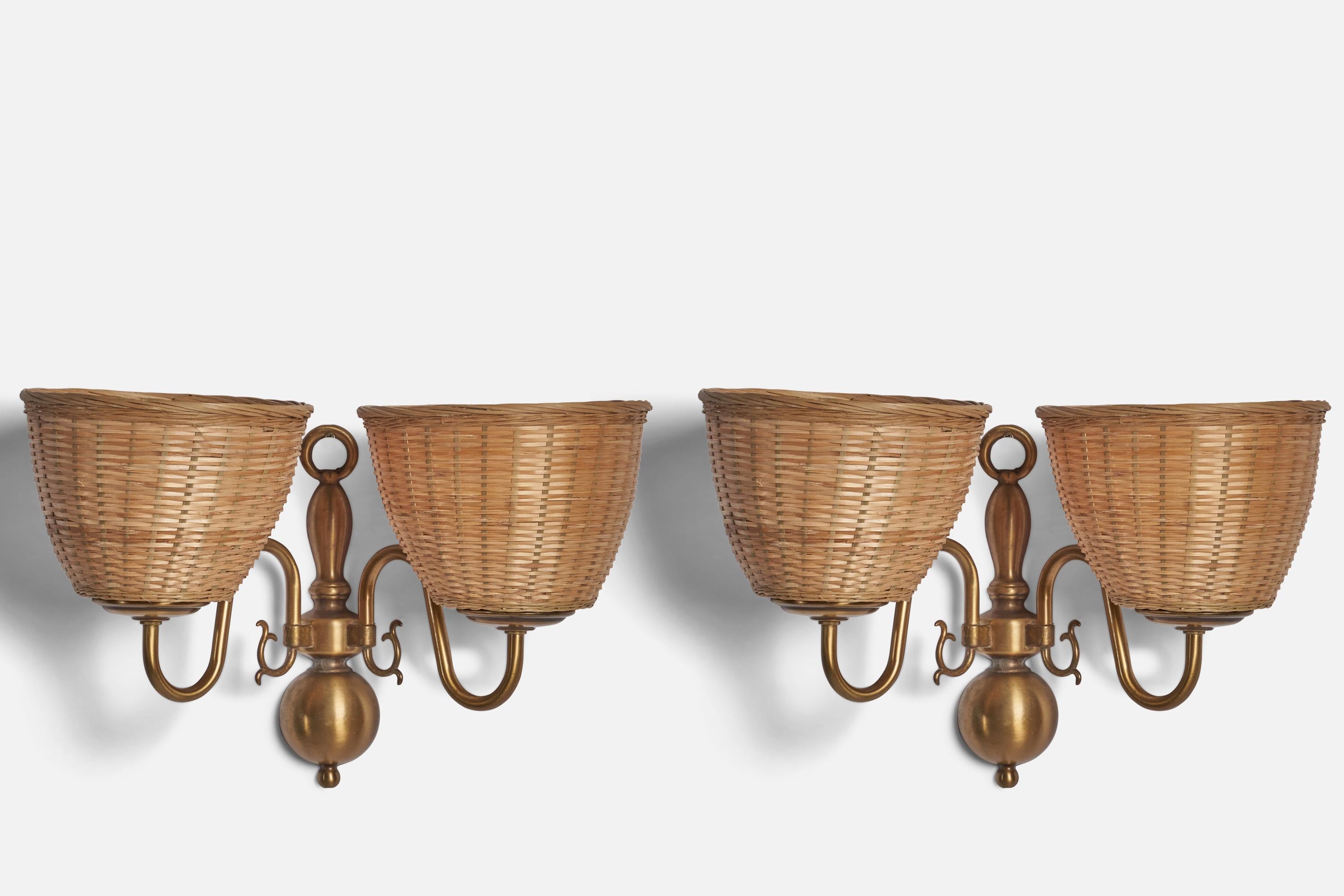 A pair of brass and rattan wall lights designed and produced in Sweden, c. 1970s.

Overall Dimensions (inches): 9.25” H x 14.25” W x 7.5” D
Back Plate Dimensions (inches): 8.75” H x 2.5” W x 1.25” D
Bulb Specifications: E-12 Bulb
Number of Sockets:
