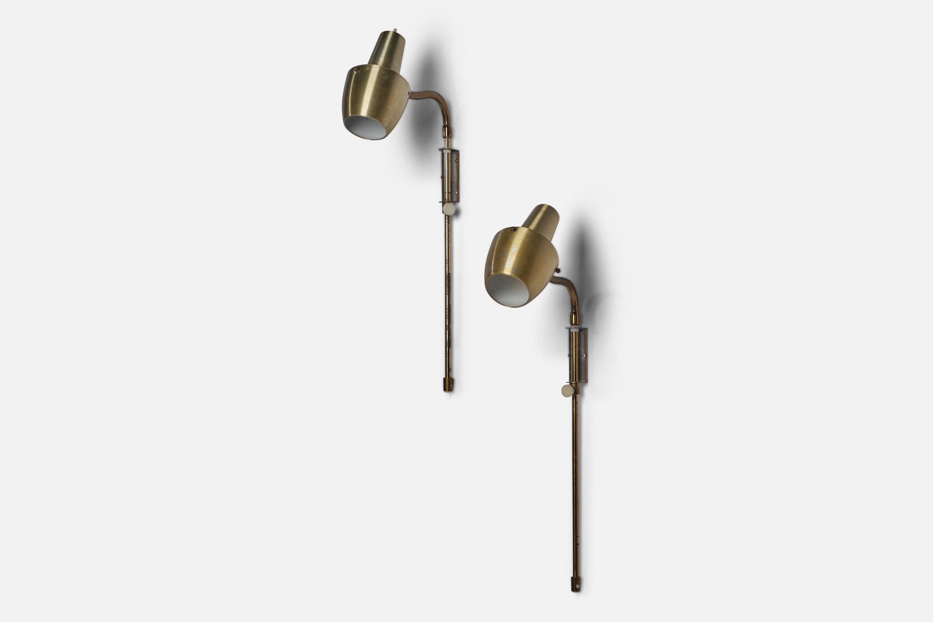 A pair of adjustable brass wall lights designed and produced in Sweden, 1970s.

Overall Dimensions (inches): 25” H x 4” W x 9.25” D
Back Plate Dimensions (inches): 3.25” H x 1.15” W x 0.25” D
Bulb Specifications: E-26 Bulb
Number of Sockets: 1
All