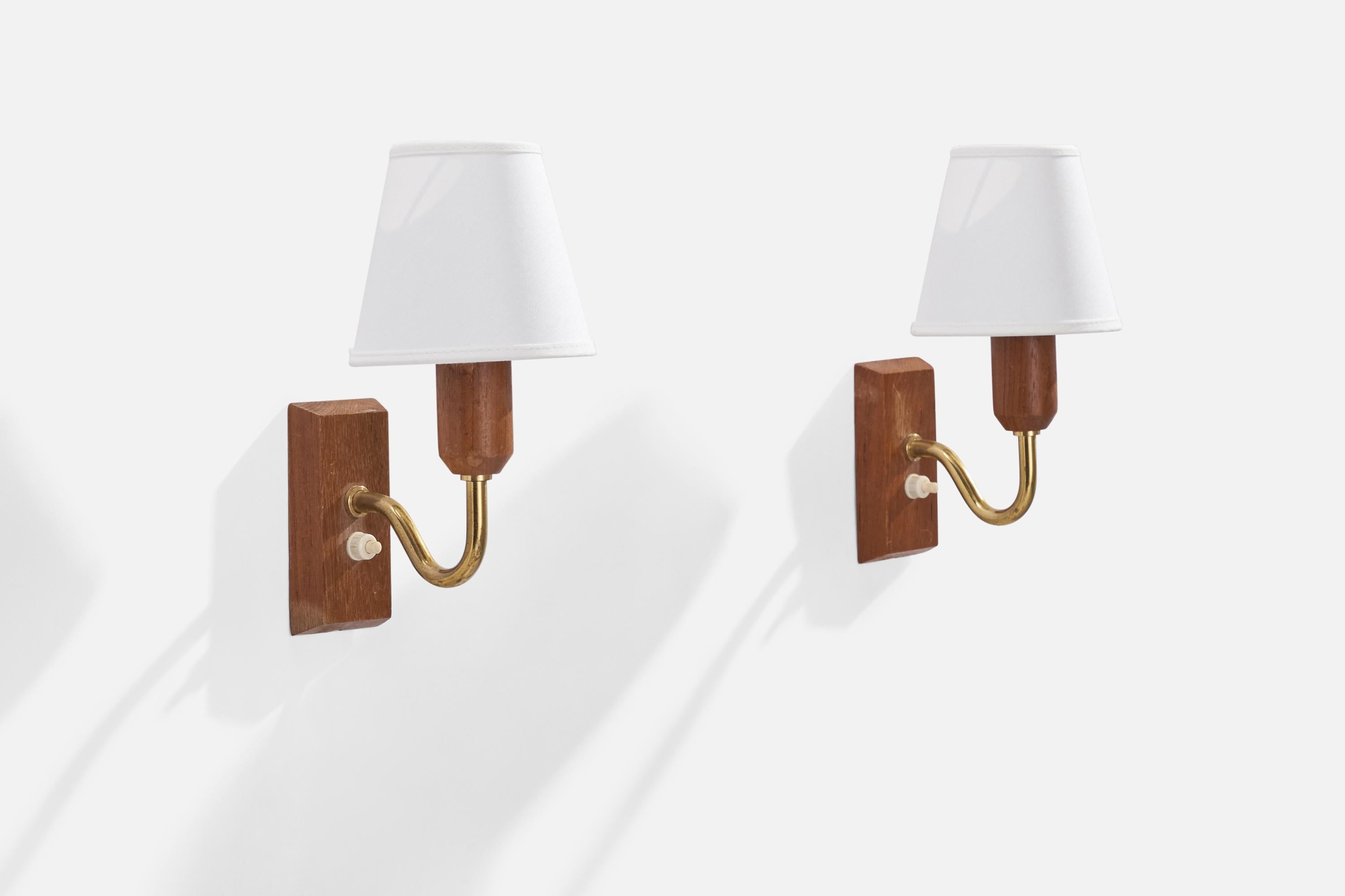 A pair of brass, white fabric and teak wall lights designed and produced in Sweden, 1950s.

Overall Dimensions (inches): 8.67” H x 3.94” W x 6.3”  D
Back Plate Dimensions (inches): 4.5” H x 2.25” W x .75”  D
Bulb Specifications: E-14 Bulb
Number of