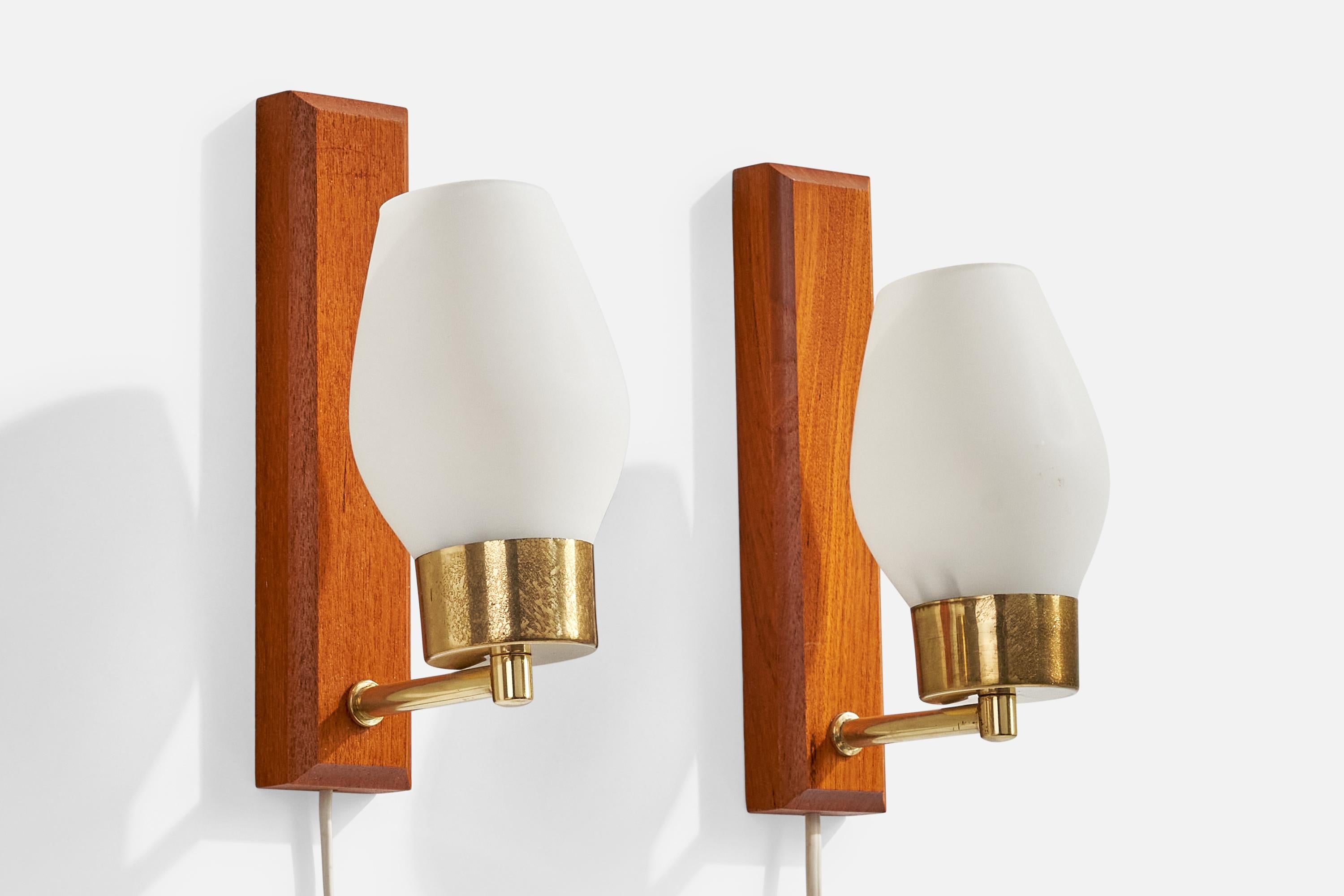 A pair of brass, teak and white opaline glass wall lights designed and produced in Sweden, c. 1950s.

Overall Dimensions (Inches): 8.25” H x 3.25” W x 4.75“ D

Back Plate Dimensions (Inches): 8.25” H x 1.875“ W x .875” D

Bulb Specifications: