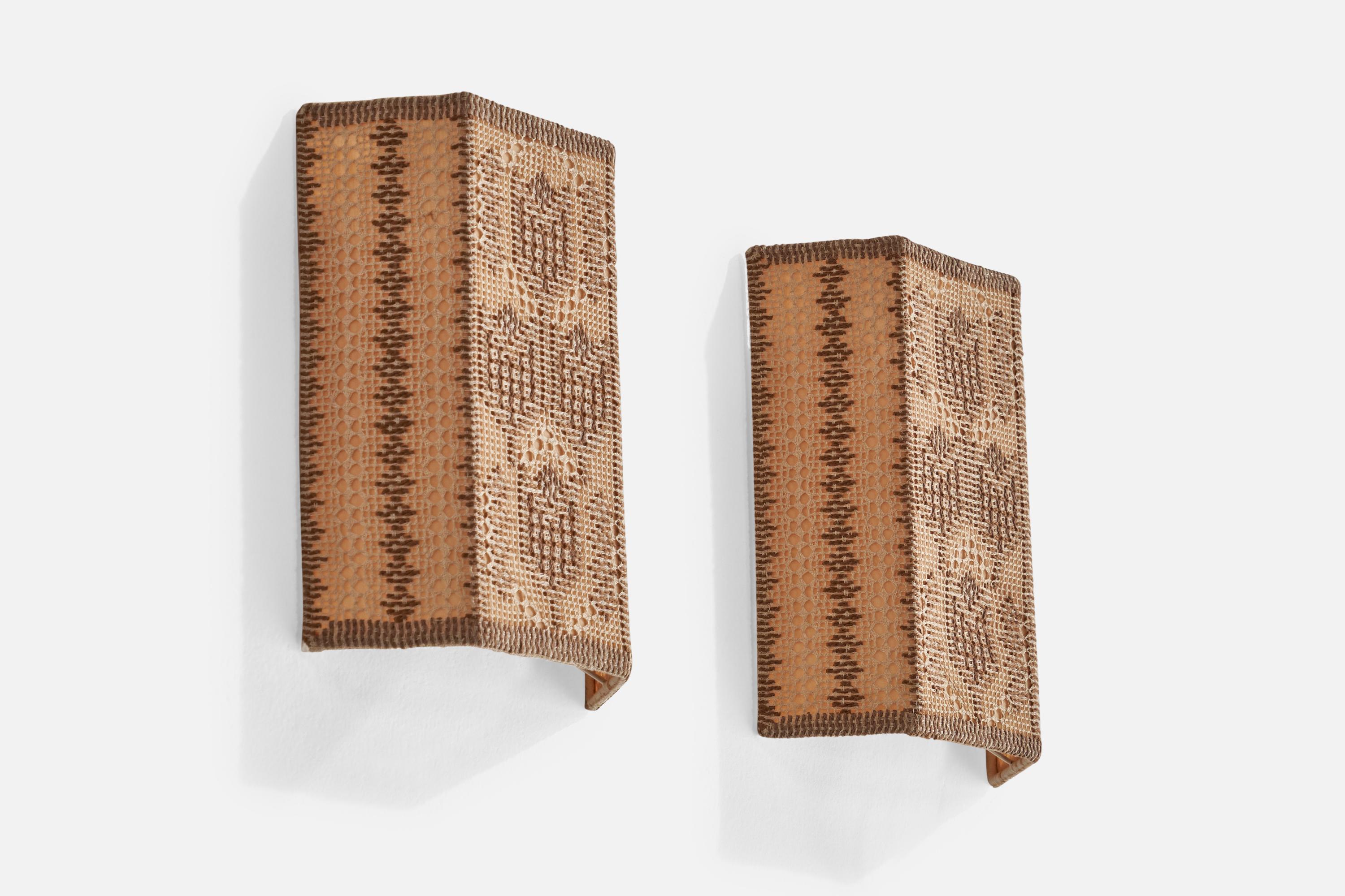 A pair of beige embroidery fabric wall lights designed and produced in Sweden, 1950s.

Overall Dimensions (inches): 10” H x 7.5” W x 2.5” D
Back Plate Dimensions (inches): N/A
Bulb Specifications: E-14 Bulb
Number of Sockets: 2
All lighting will be