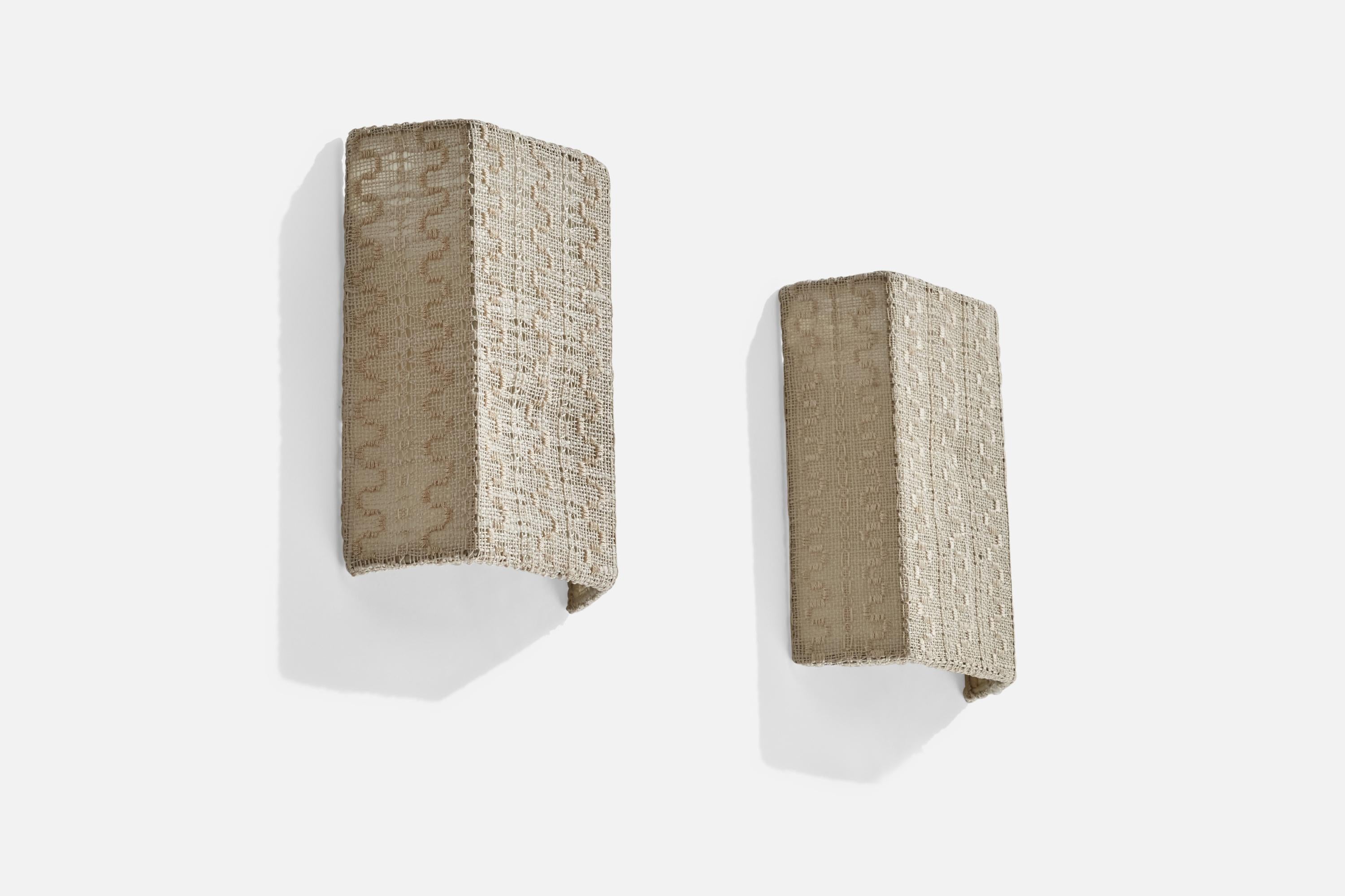 A pair of off-white embroidery fabric wall lights designed and produced in Sweden, 1950s. 

Overall Dimensions (inches): 10” H x 7.25” W x 2.5” D
Back Plate Dimensions (inches): N/A
Bulb Specifications: E-14 Bulb
Number of Sockets: 2
All lighting