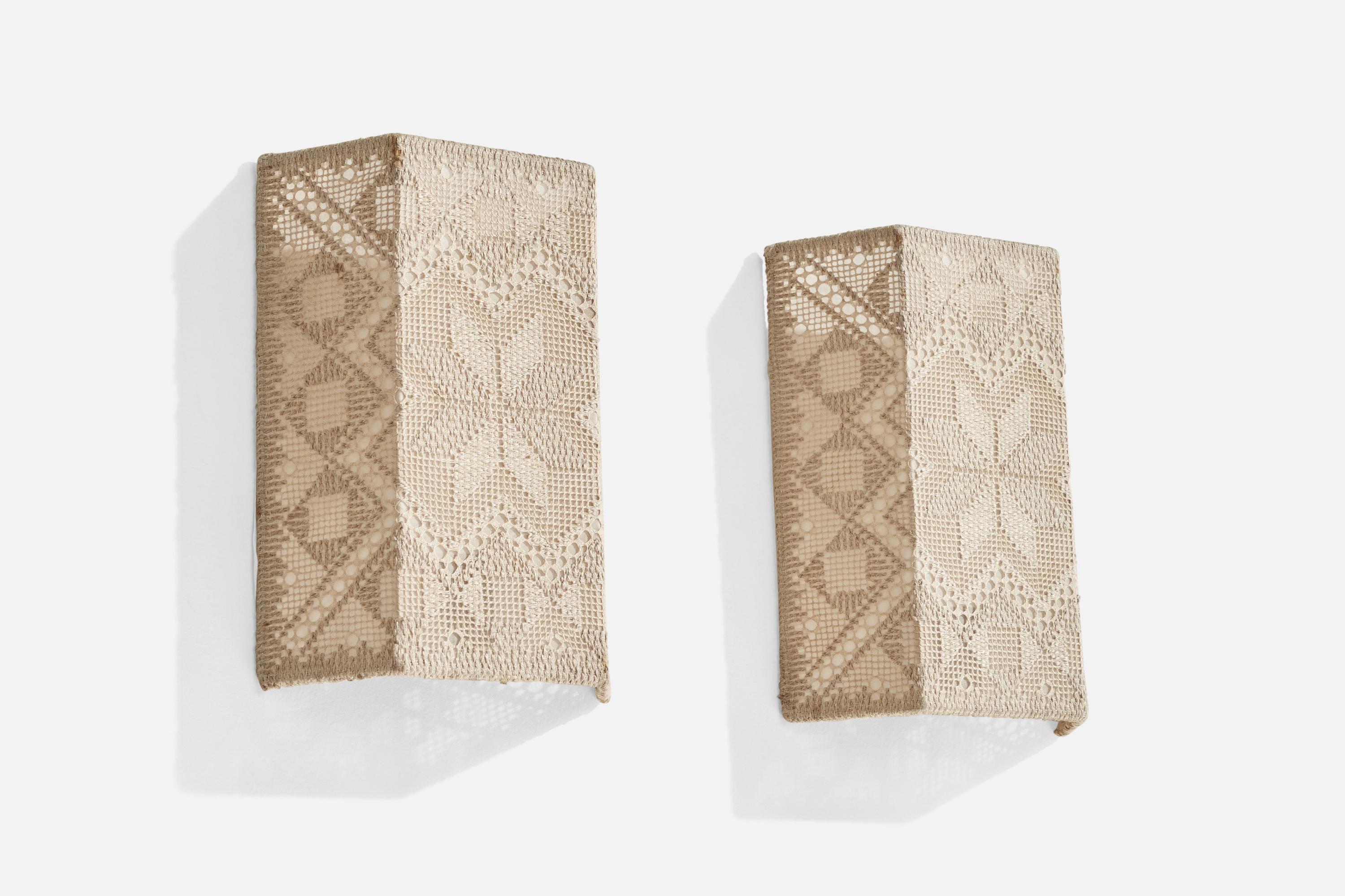 A pair of metal and hand-embroidered fabric wall lights designed and produced in Sweden, c. 1960s.

Overall Dimensions (inches): 10.5”  H x 7.75” W x 2.75” D
Back Plate Dimensions (inches): N/A
Bulb Specifications: E-12 Bulb
Number of Sockets: 2
All