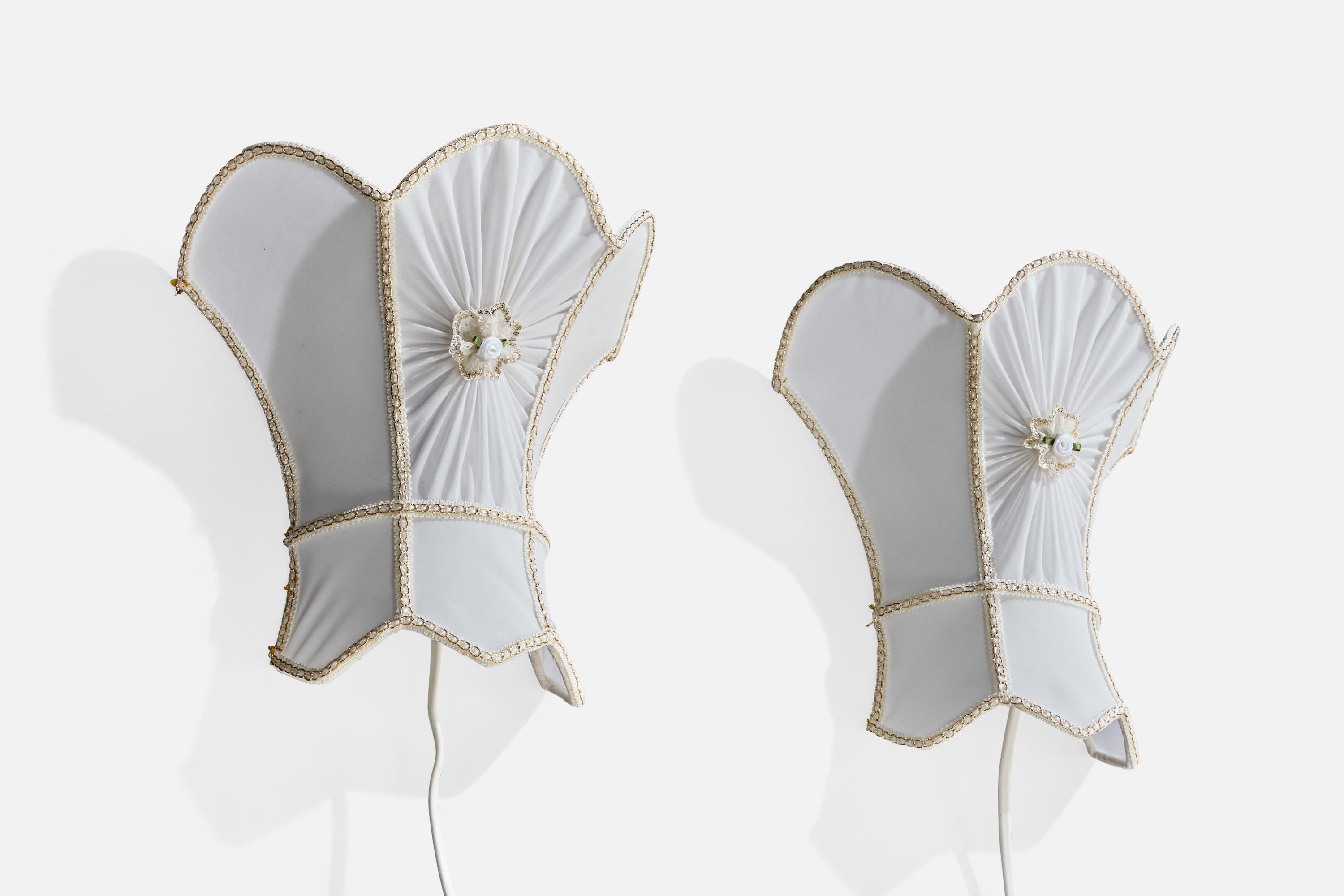 A pair of white fabric wall lights designed and produced in Sweden, c. 1970s.

Overall Dimensions (inches): 10.25