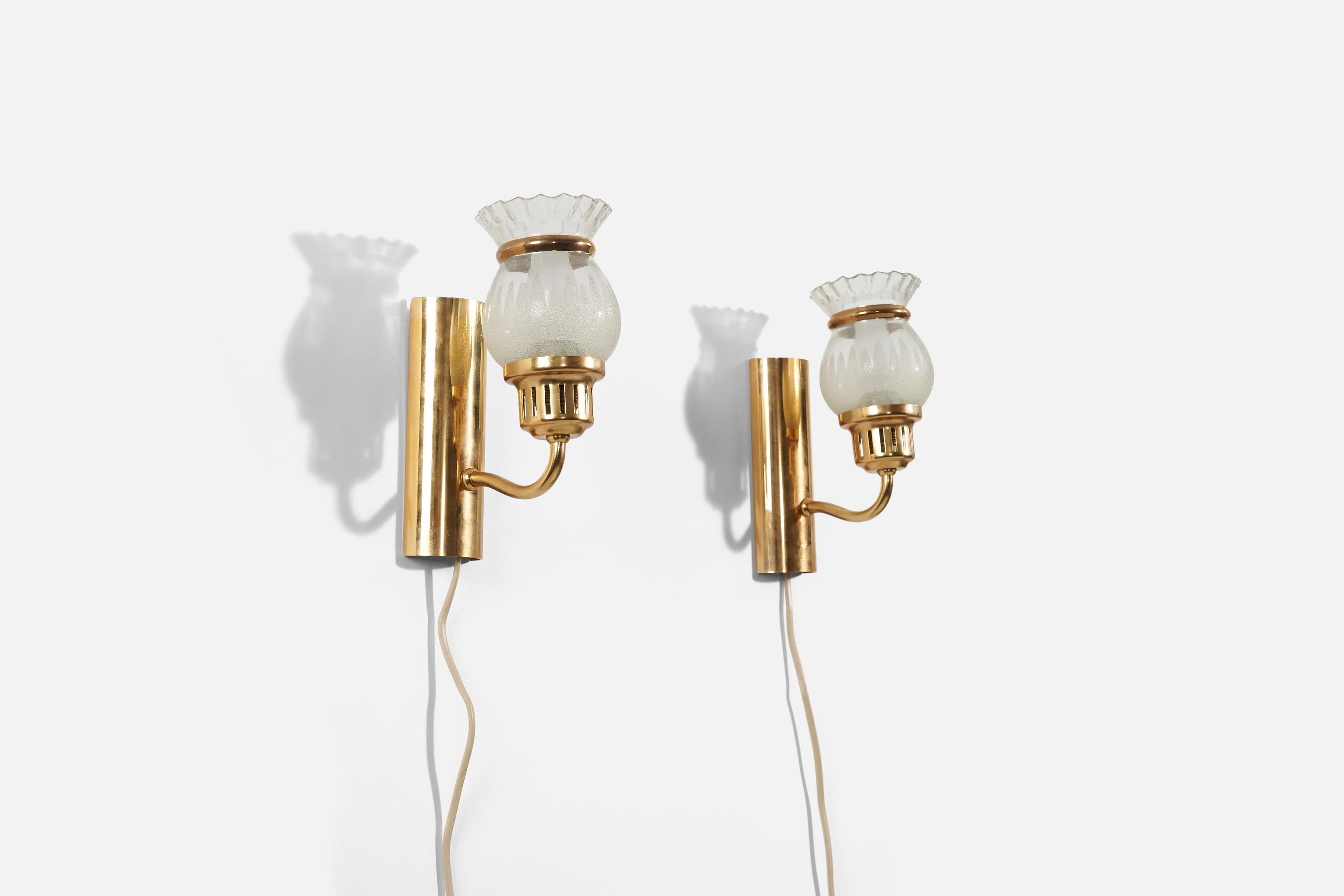 A pair of wall lights in brass, glass, and metal designed and produced in Sweden, 1950s.