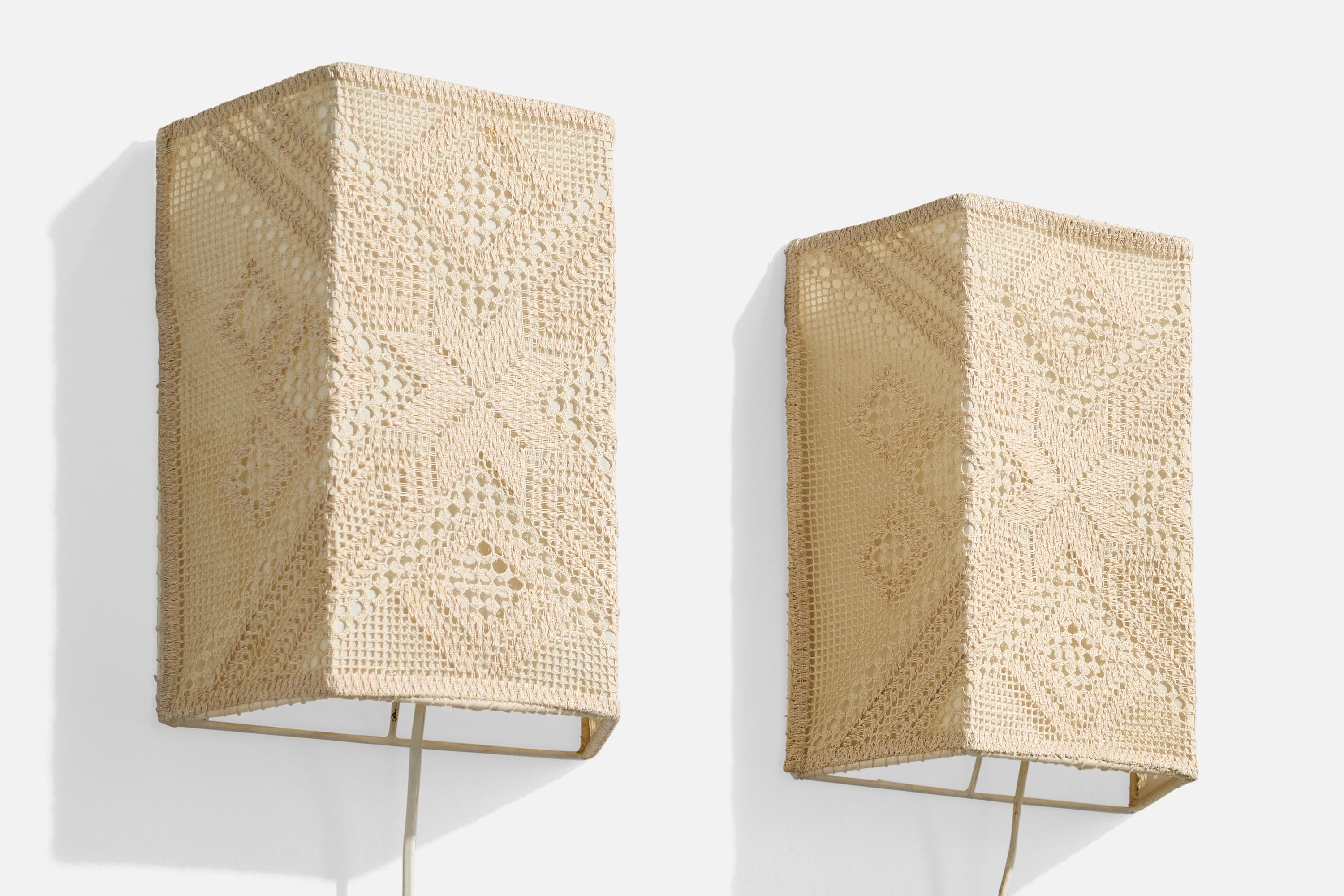 A pair of beige embroidery fabric and metal wall lights designed and produced in Sweden, c. 1960s.

Overall Dimensions (Inches): 10” H x 8” W x 3.85“ D

Bulb Specifications: E-14

Number of Sockets (per fixture): 1

Does not include mounting