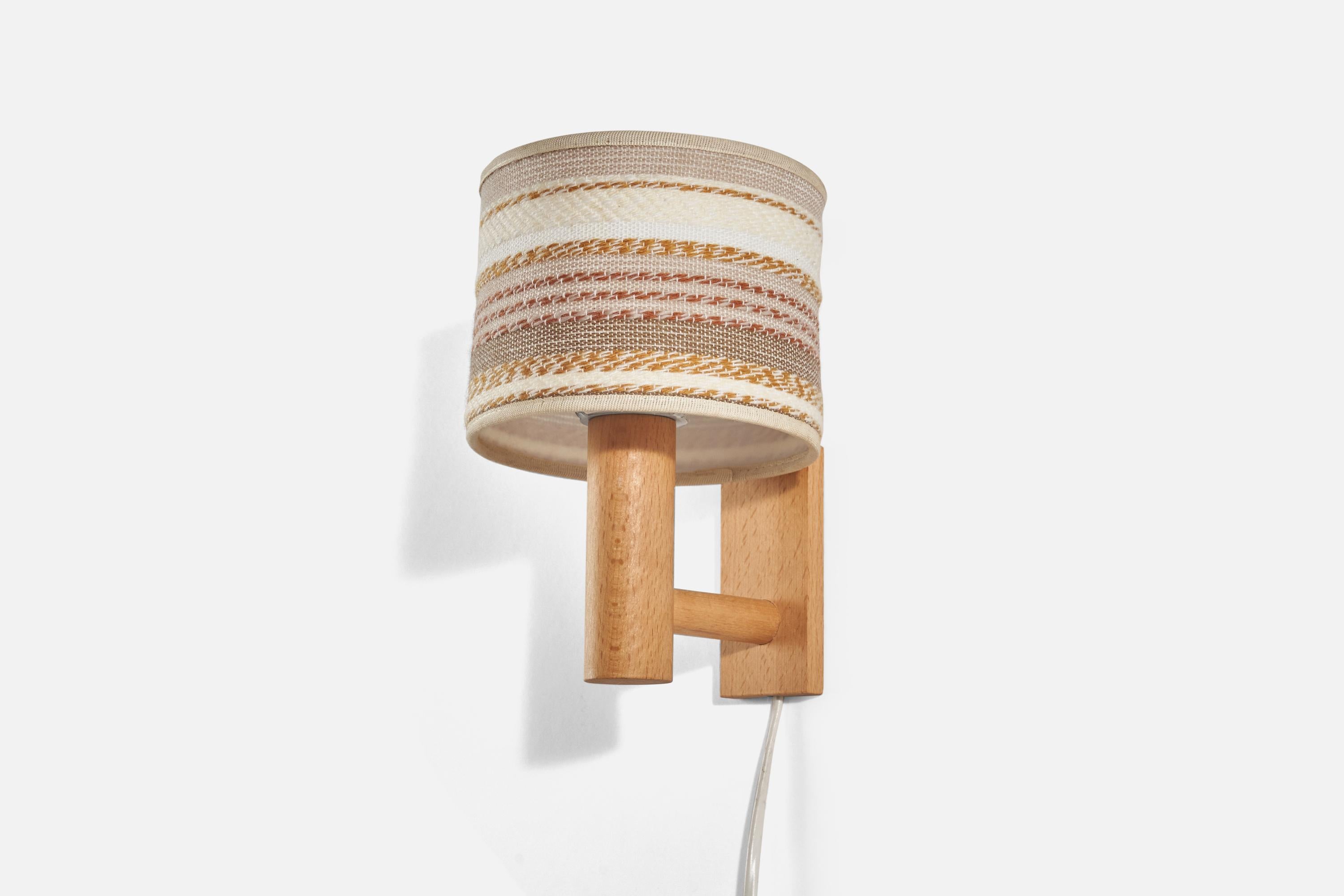 A pair of oak and woven fabric wall lights designed and produced in Sweden, 1970s.

Sold with Lampshade(s). Dimensions stated are of Sconce with Shade(s).

Dimensions of Back Plate (inches) : 4.16 x 1.94 x 0.43 (Height x Width x Depth)

Socket