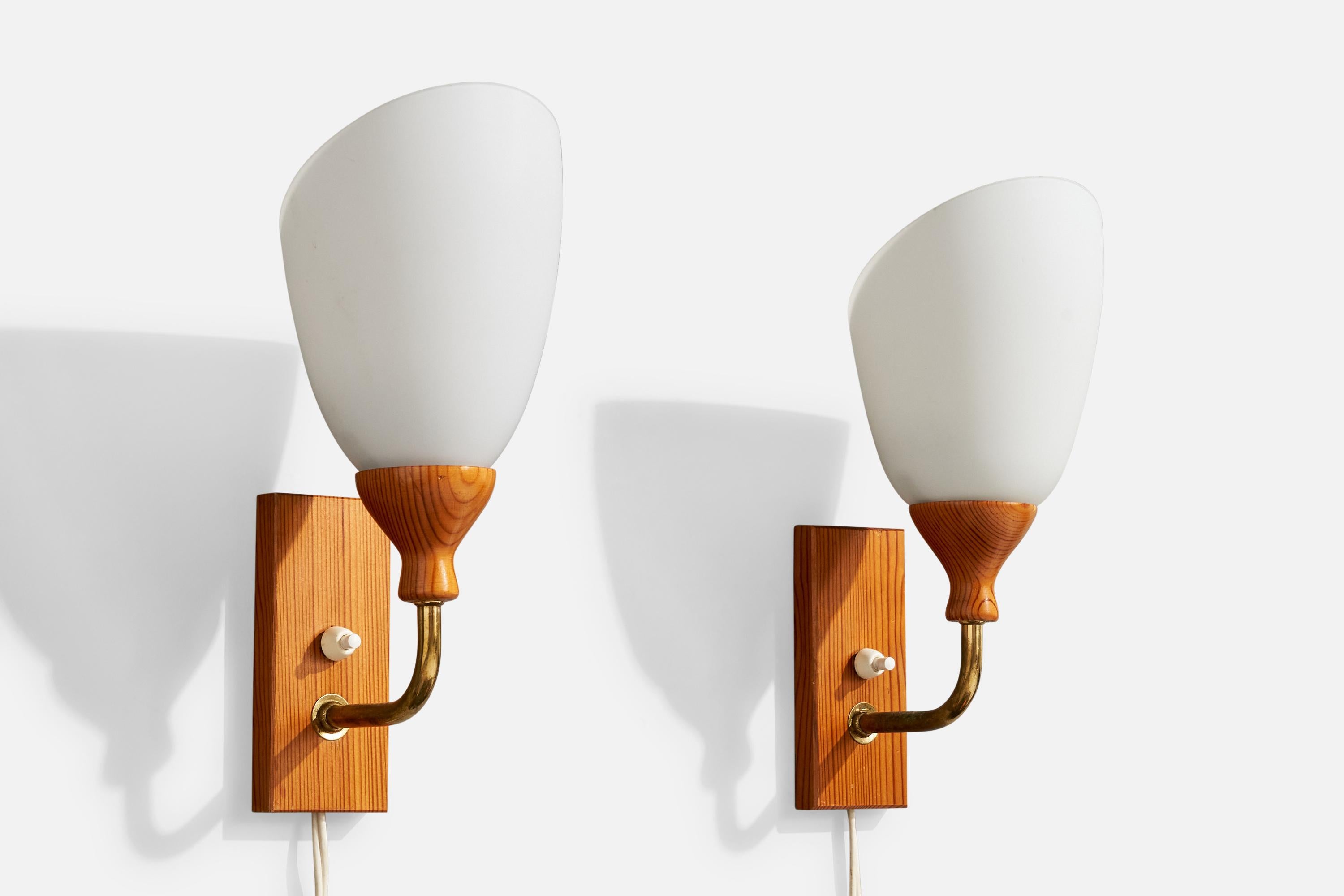 A pair of pine, brass and white opaline glass wall lights designed and produced in Sweden, c. 1950s.

Overall Dimensions (Inches): 12” H x 4.75” W x 6“ D

Back Plate Dimensions (Inches): 5.5” H x 2.5“ W x .75” D

Bulb Specifications: E-26