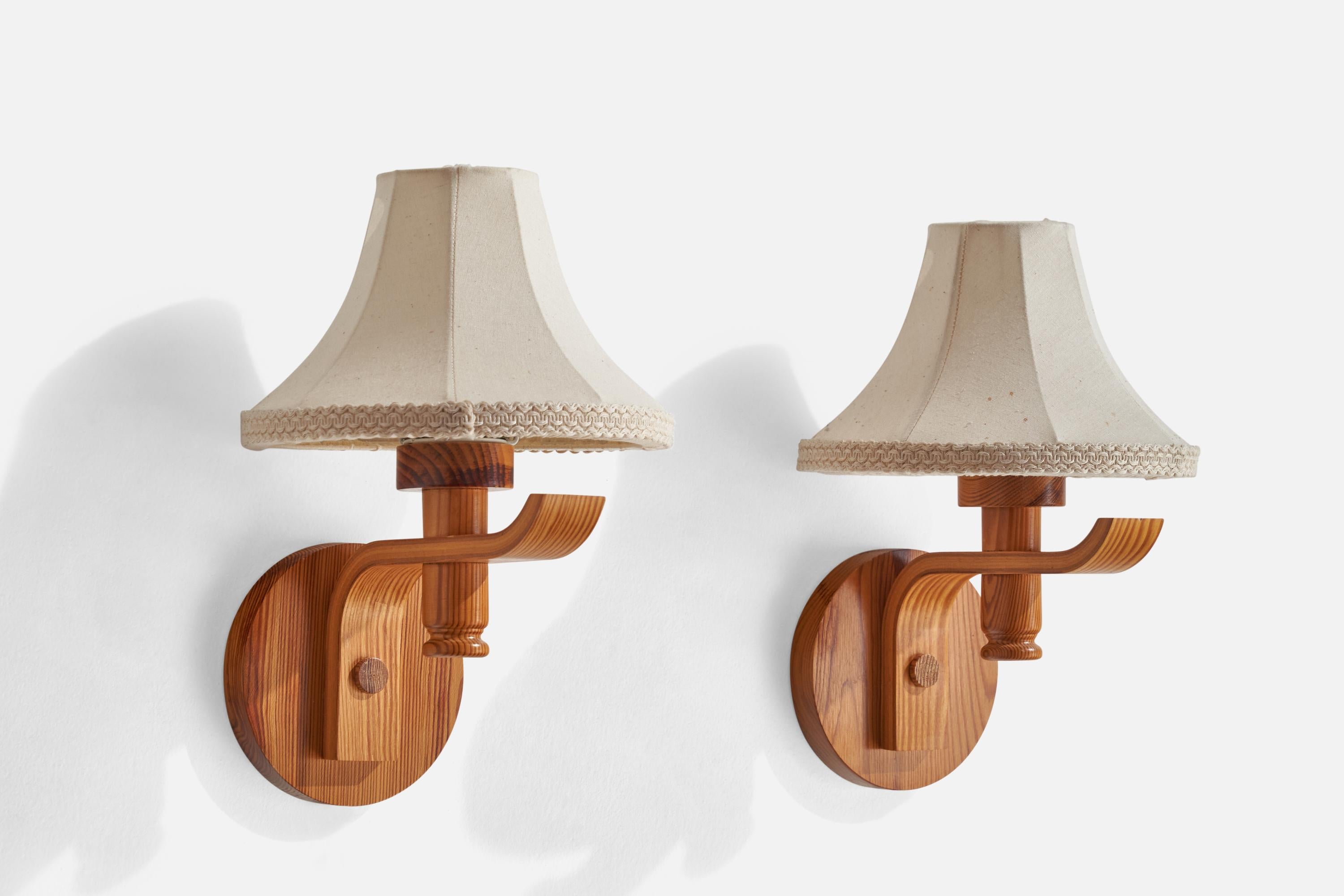 
A pair of pine and off-white fabric wall lights designed and produced in Sweden, 1970s.
Overall Dimensions (inches): 8.75” H x 5.5” W x 7.5” D
Stated dimensions include shade.
Bulb Specifications: E-26 Bulb
Number of Sockets: 2
All lighting will be