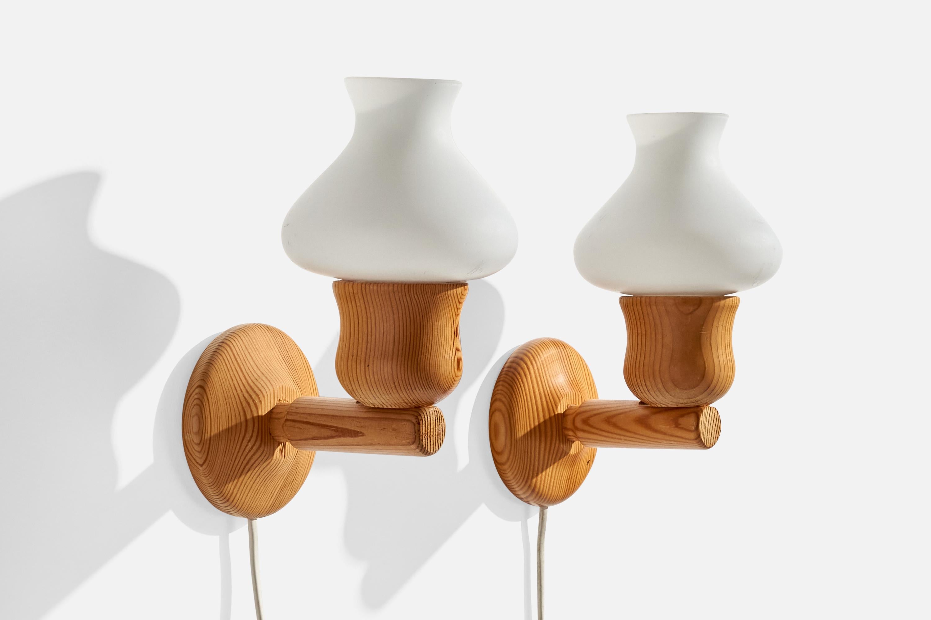 A pair of pine and opaline glass wall lights designed and produced in Sweden, c. 1970s.

Overall Dimensions (inches):  8.5” H x  5.125” W x 6.24 “D
Back Plate Dimensions (Inches):  3.75” H x 3.75” W x .75” D
Bulb Specifications: E-14 Bulbs
Number of