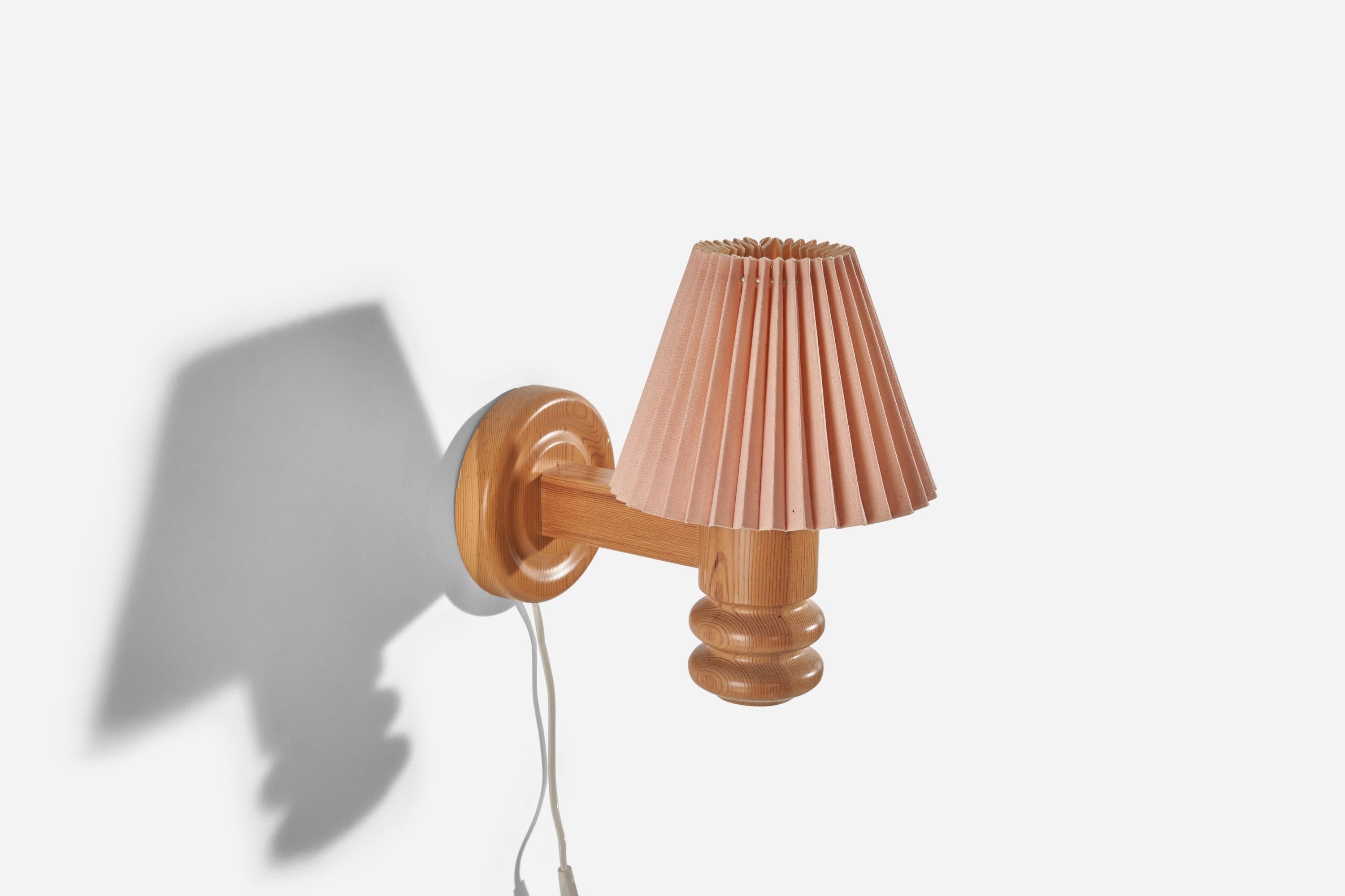 A pair of pine and pink paper wall lights designed and produced in Sweden, 1970s.

Sold with Lampshade(s). Stated dimensions refer to the Sconce with the Shade(s).

Dimensions of Back Plate (inches) : 5.3 x 5.3 x 1.06 (Height x Width x