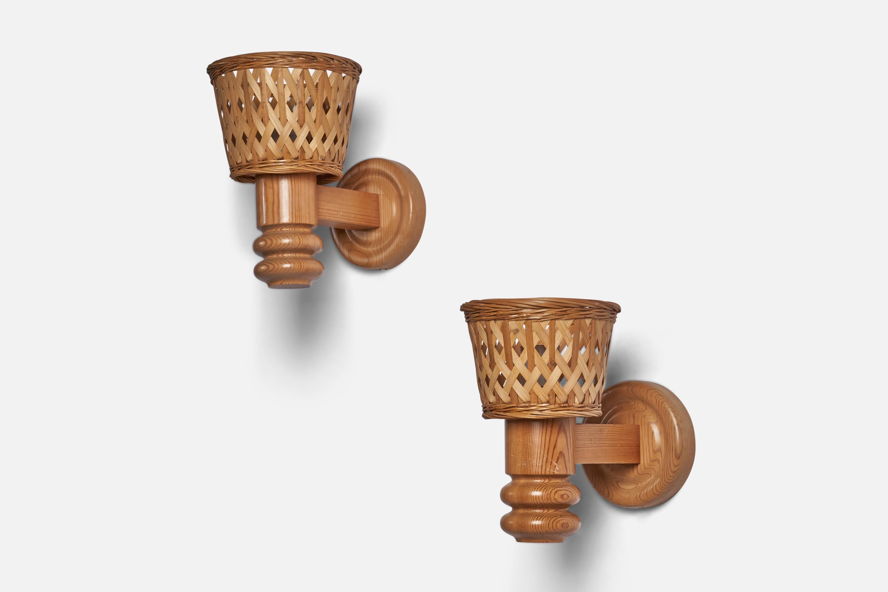 A pair of pine and rattan wall lights designed and produced in Sweden, c. 1970s.

Overall Dimensions (inches): 9.75” H x 6.25” W x 10.5” D
Back Plate Dimensions (inches): 5.4” Diameter
Bulb Specifications: E-26 Bulb
Number of Sockets: 1
All lighting