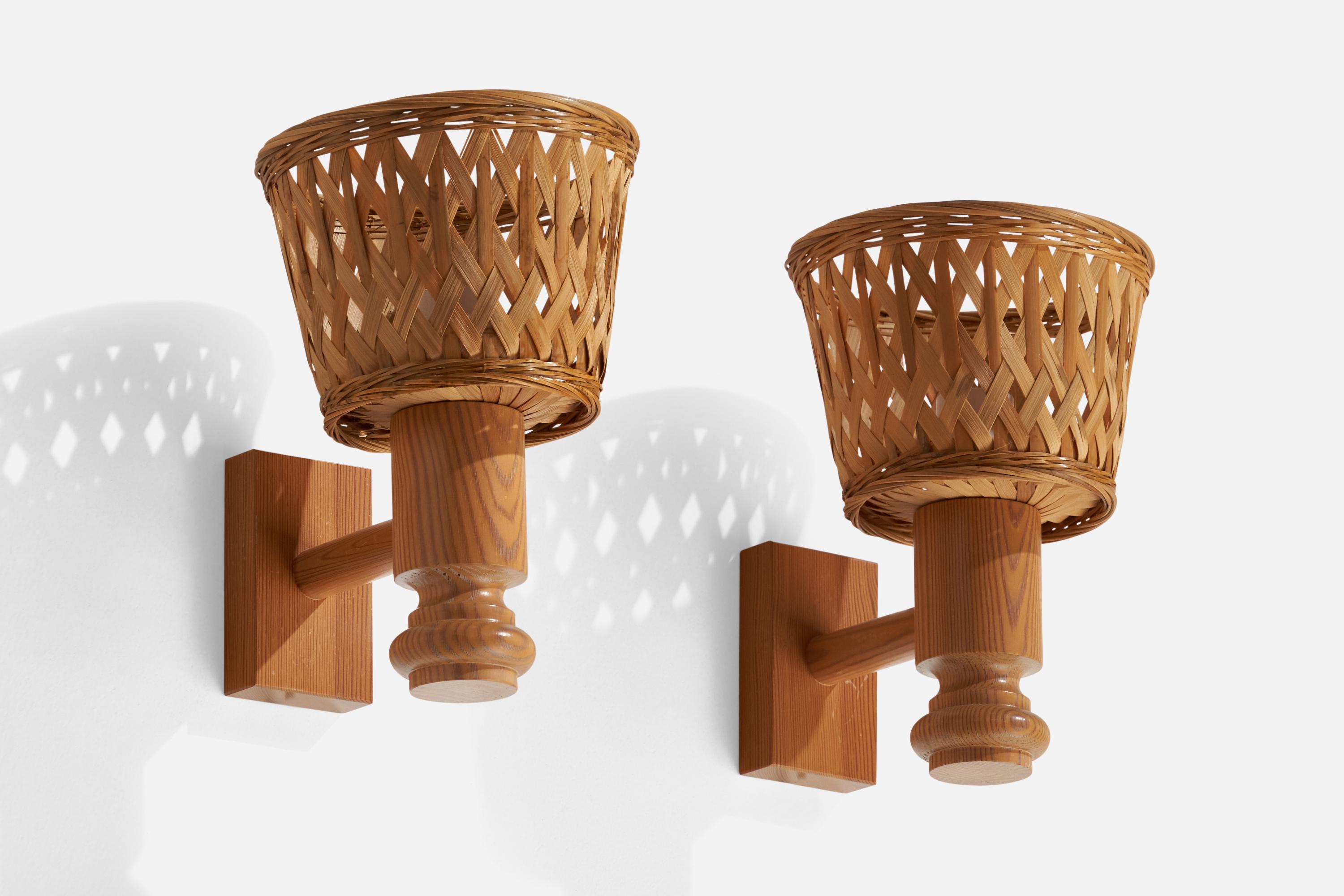 A pair of pine and rattan wall lights designed and produced in Sweden, c. 1970s.

Overall Dimensions (inches): 10.25” H x 7.1” W x 9.05” D
Back Plate Dimensions (inches): 4.55” H x 2.75” W x 1.05” D
Bulb Specifications: E-26 Bulbs
Number of Sockets: