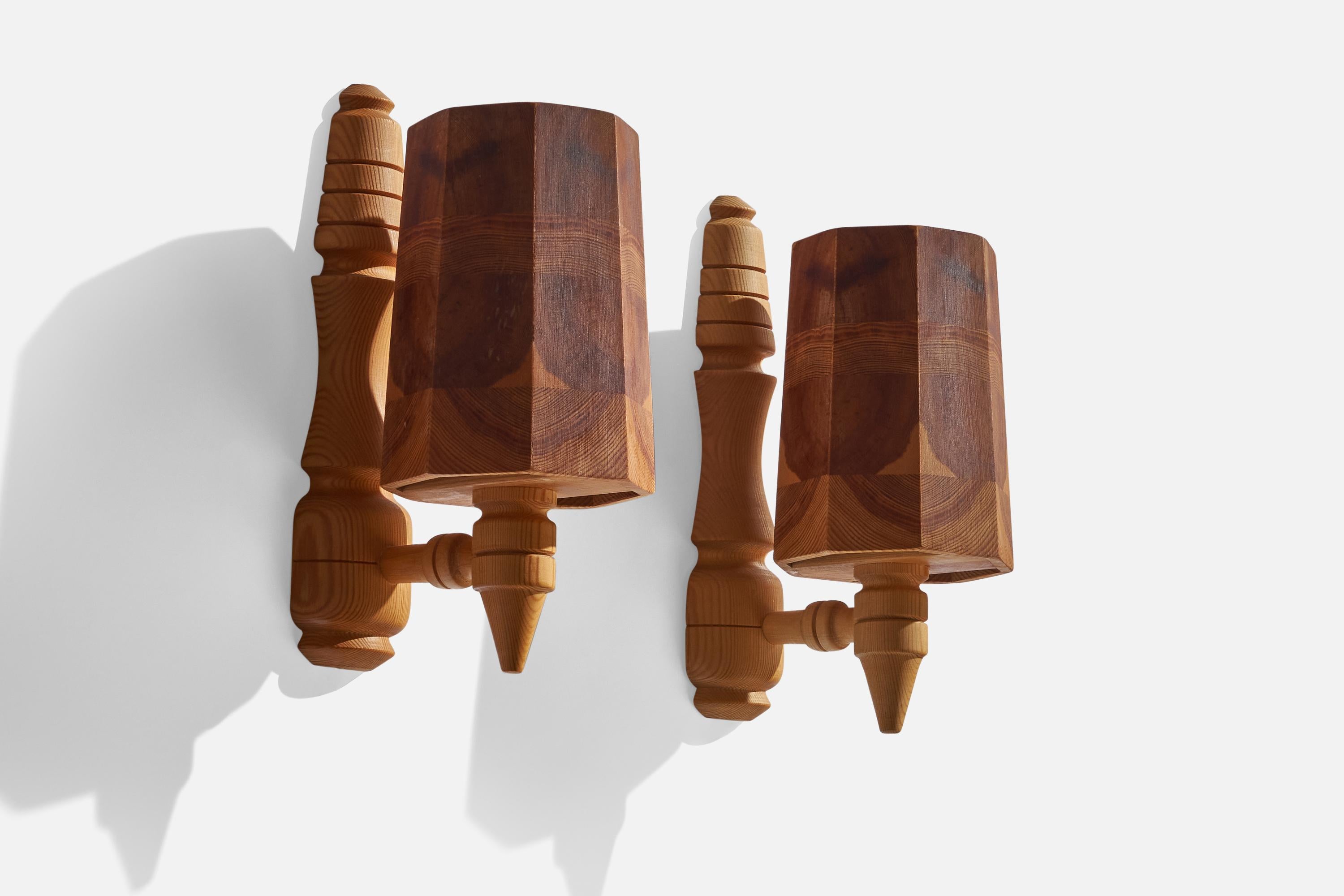 A pair of pine wall lights designed and produced in Sweden, 1970s.

Overall Dimensions (inches): 11.5” H x 5” W x 7” D
Back Plate Dimensions (inches): 11.25” H x 2.75” x 1.25” D
Bulb Specifications: E-14 Bulb
Number of Sockets: 2
All lighting will